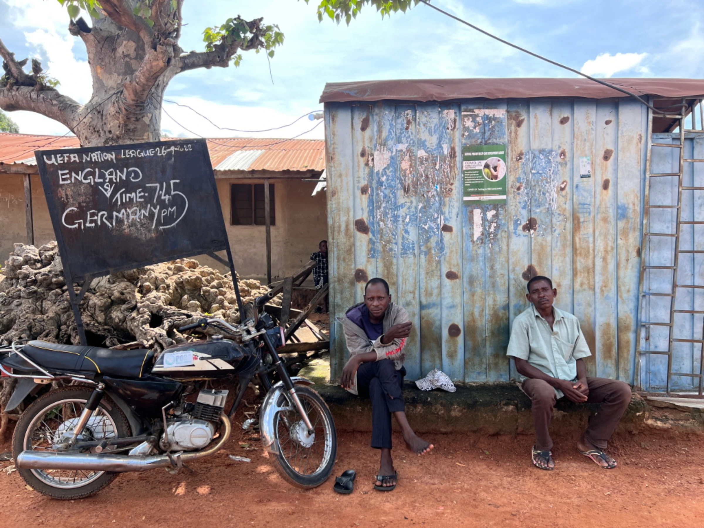 A village blackboard advertises a solar-powered TV showing of a UEFA match fixture between England and Germany at a football betting kiosk in Kiguna, Nasarawa, Nigeria, September 26, 2022. Thomson Reuters Foundation/Afolabi Sotunde