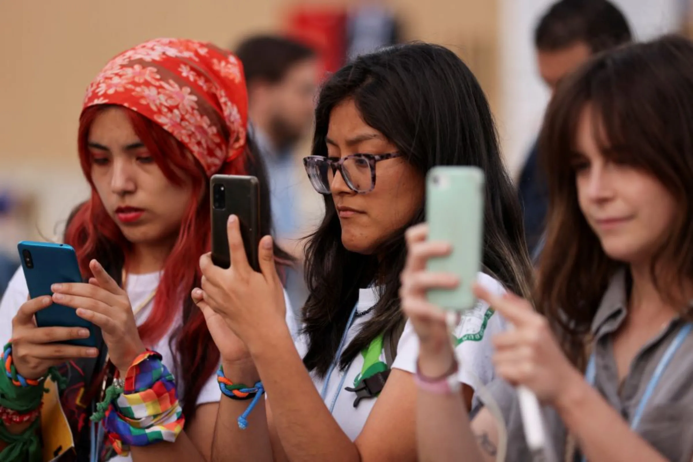 People use their phones as climate activists take part in a protest during the COP27 climate summit, in Sharm el-Sheikh, Egypt, November 17, 2022. REUTERS/Mohamed Abd El Ghany
