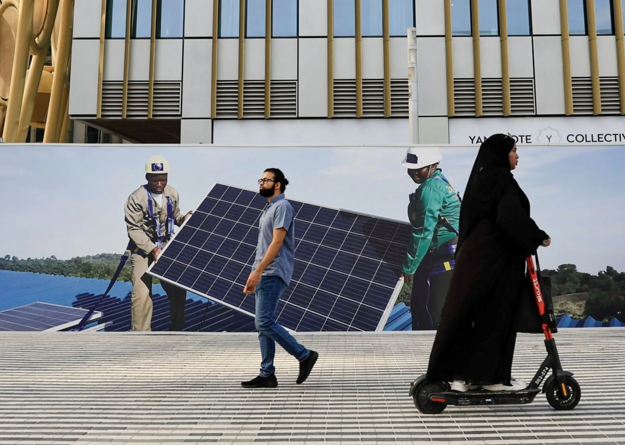 A woman rides an e-scooter in the Green zone at the United Nations Climate Change Conference (COP28) in Dubai, United Arab Emirates, December 8, 2023