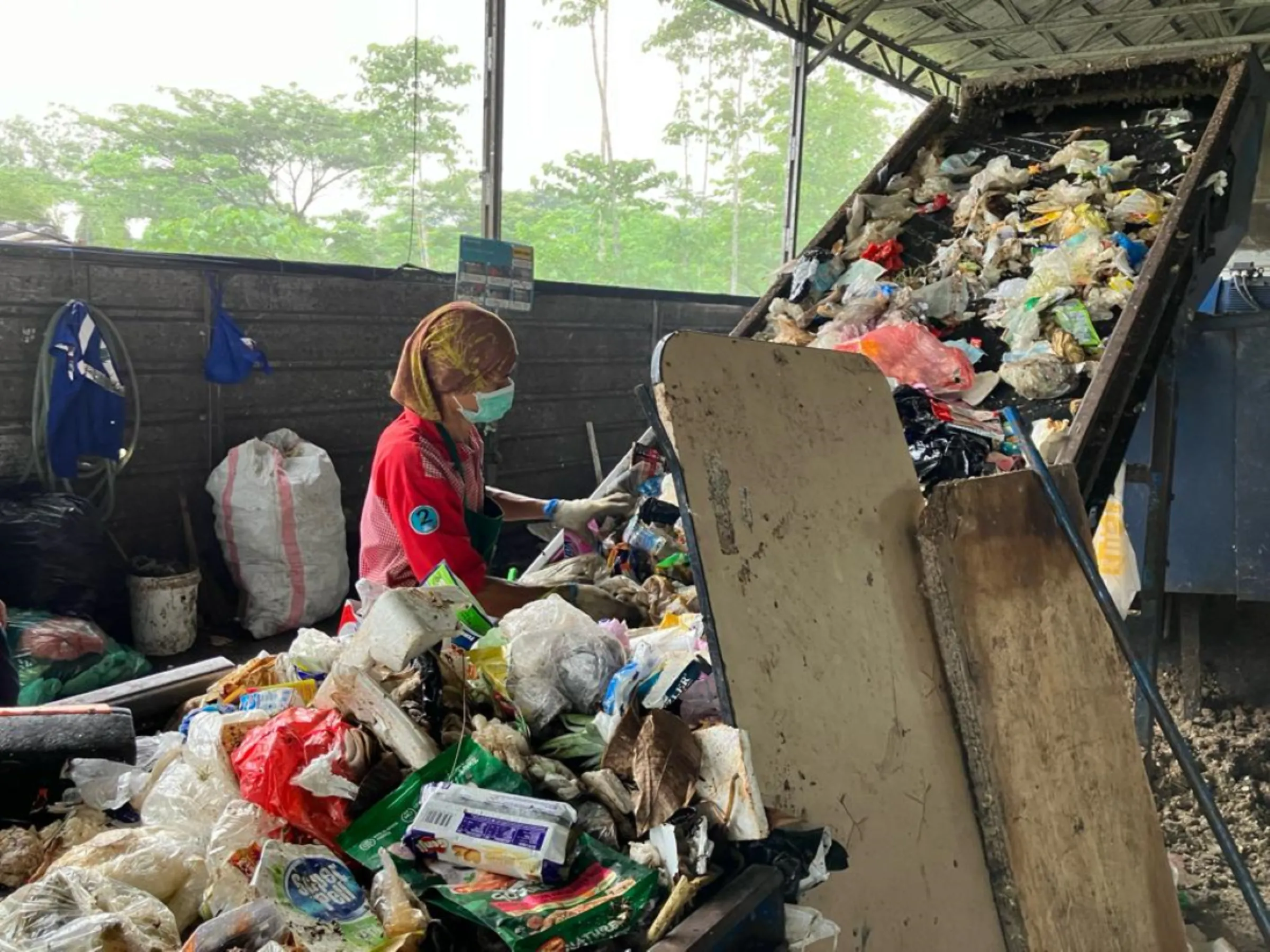 Workers sort trash at the Waste4Change recycling facility in Bekasi, Indonesia, November 24, 2023