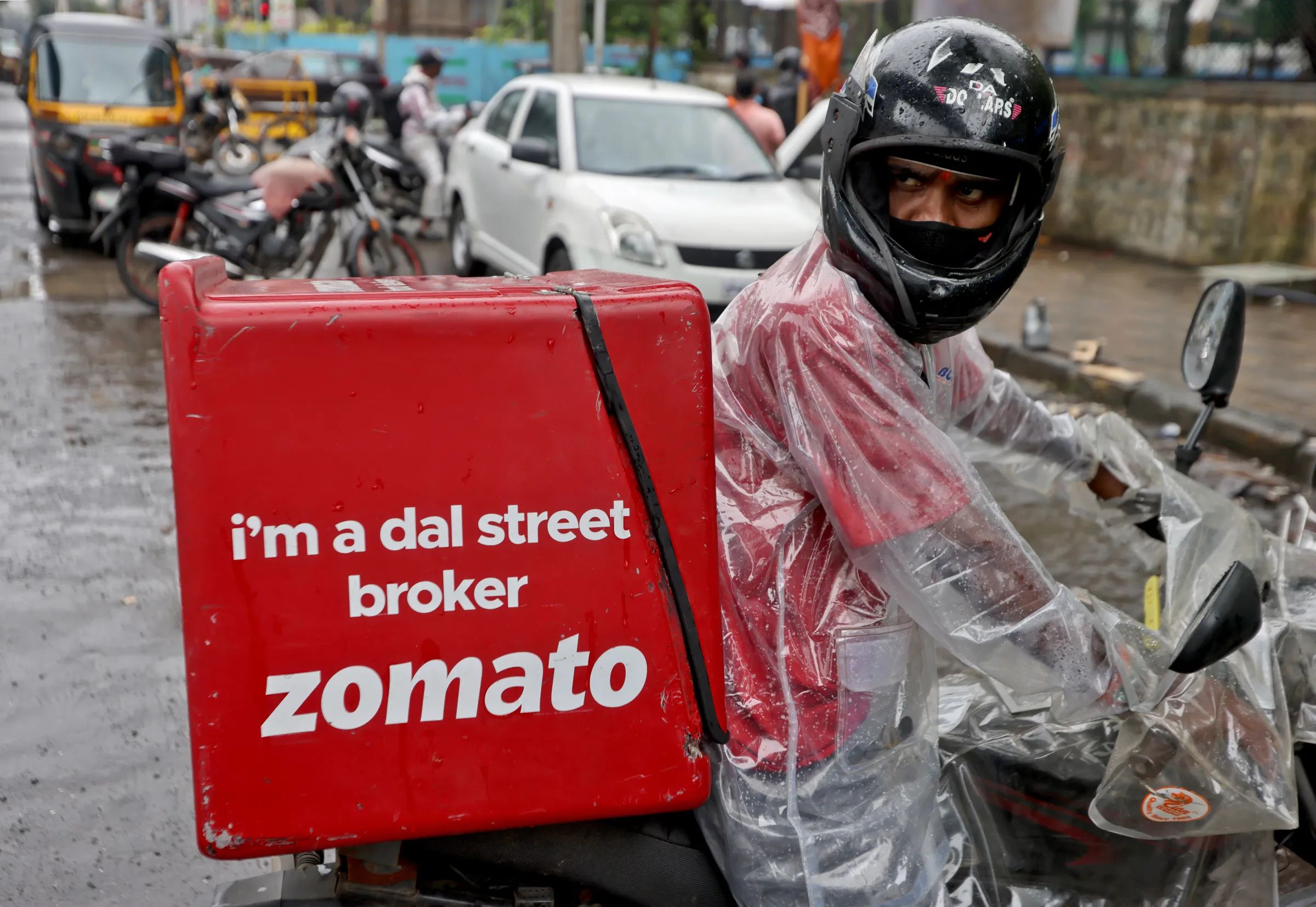A delivery worker of Zomato, an Indian food-delivery startup, prepares to leave to pick up an order from a restaurant in Mumbai, India, July 13, 2021