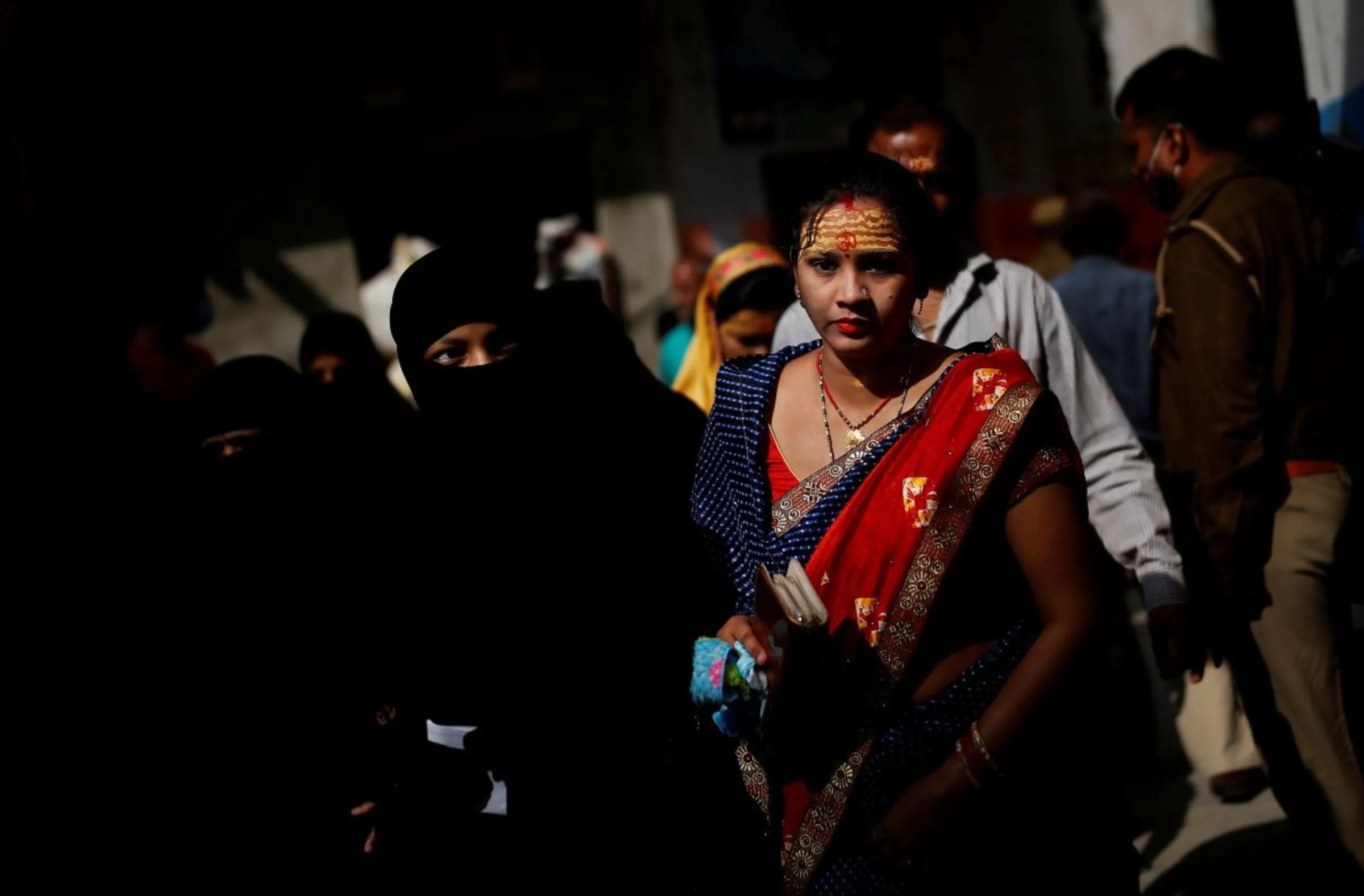 Women arrive to cast their votes at polling station during the last phase of state assembly election in Varanasi in the northern state of Uttar Pradesh, India, March 7, 2022