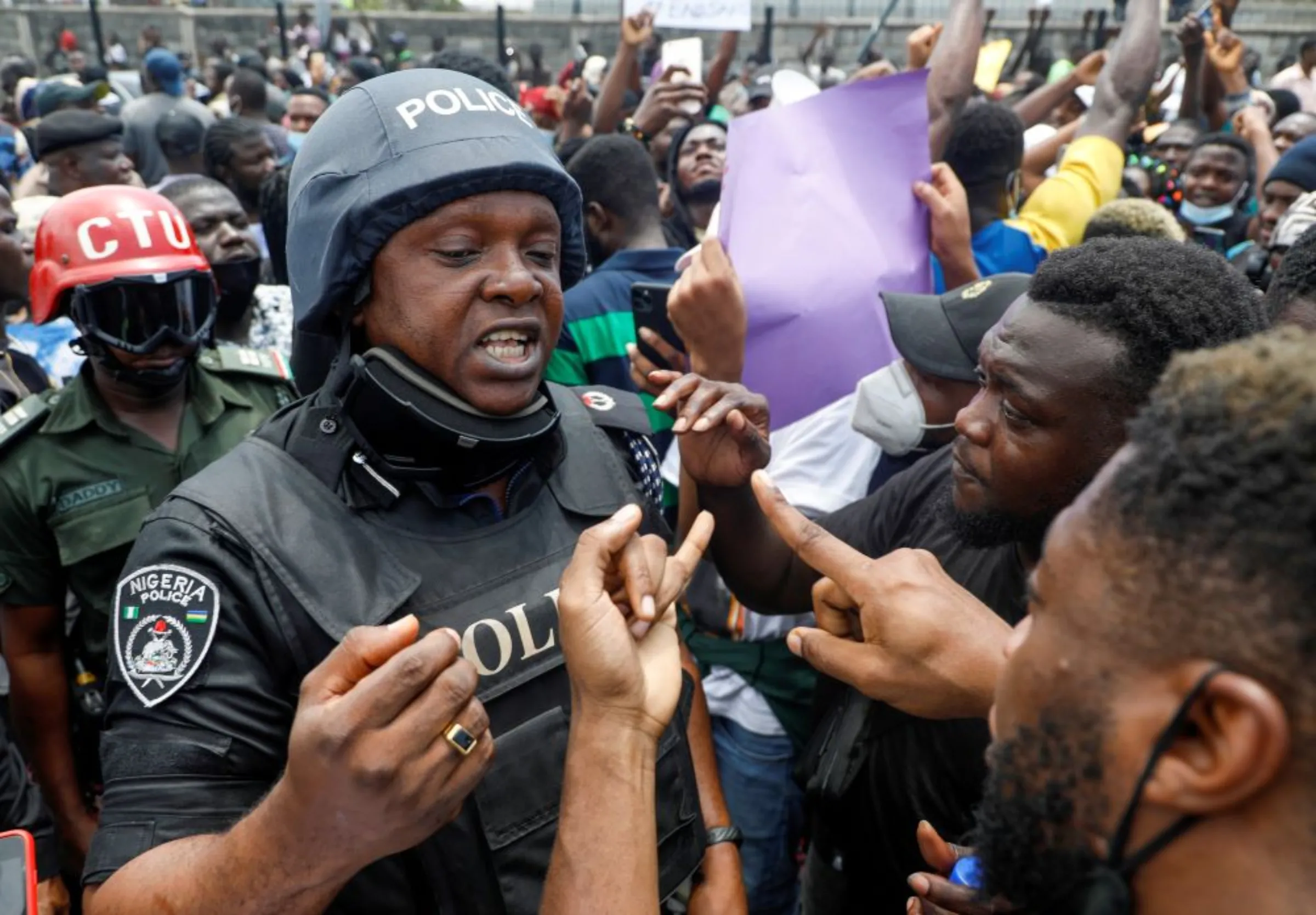 Demonstrators talk to a police officer during a protest over alleged police brutality, in Lagos, Nigeria October 12, 2020. REUTERS/Temilade Adelaja