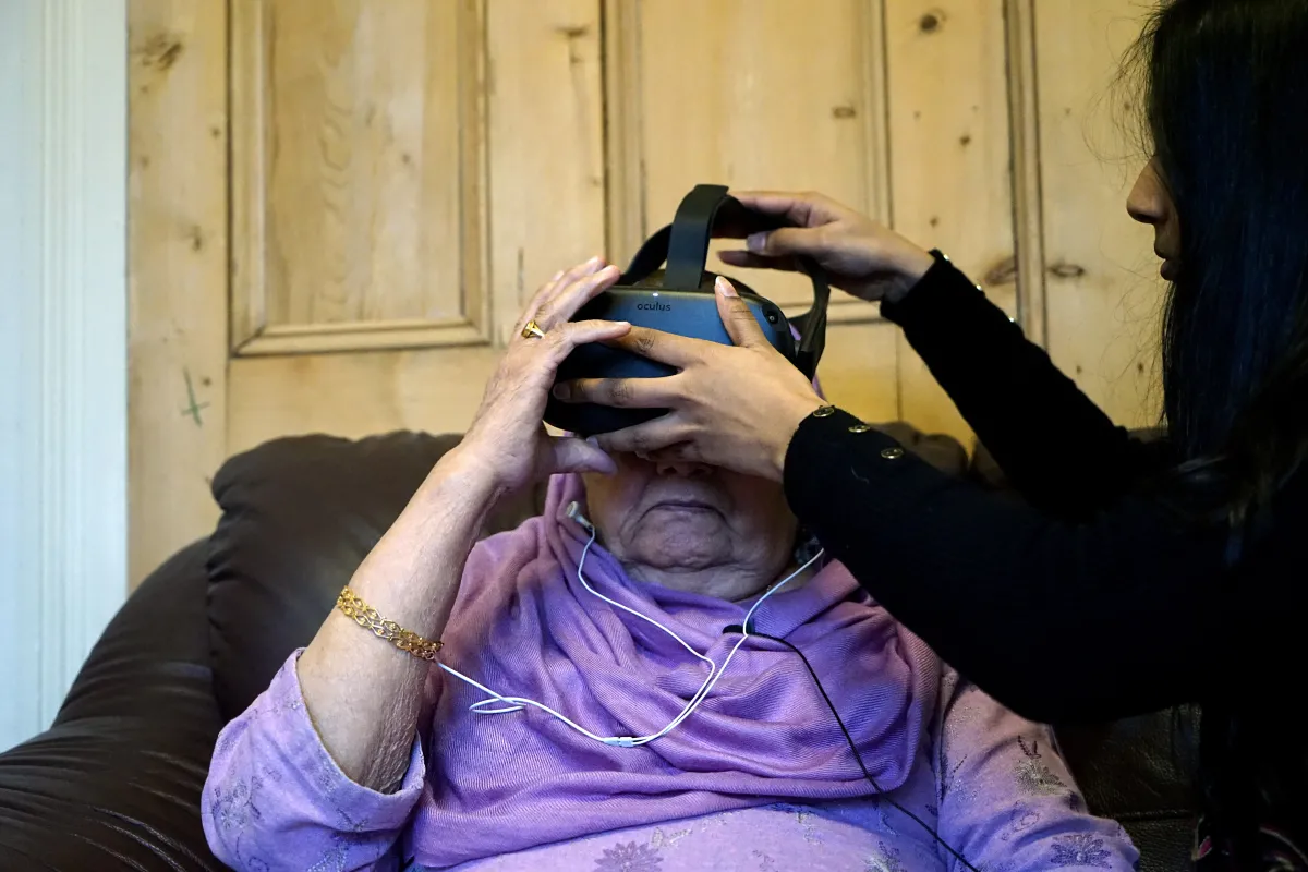 A survivor of India's Partition looks through a virtual reality headset