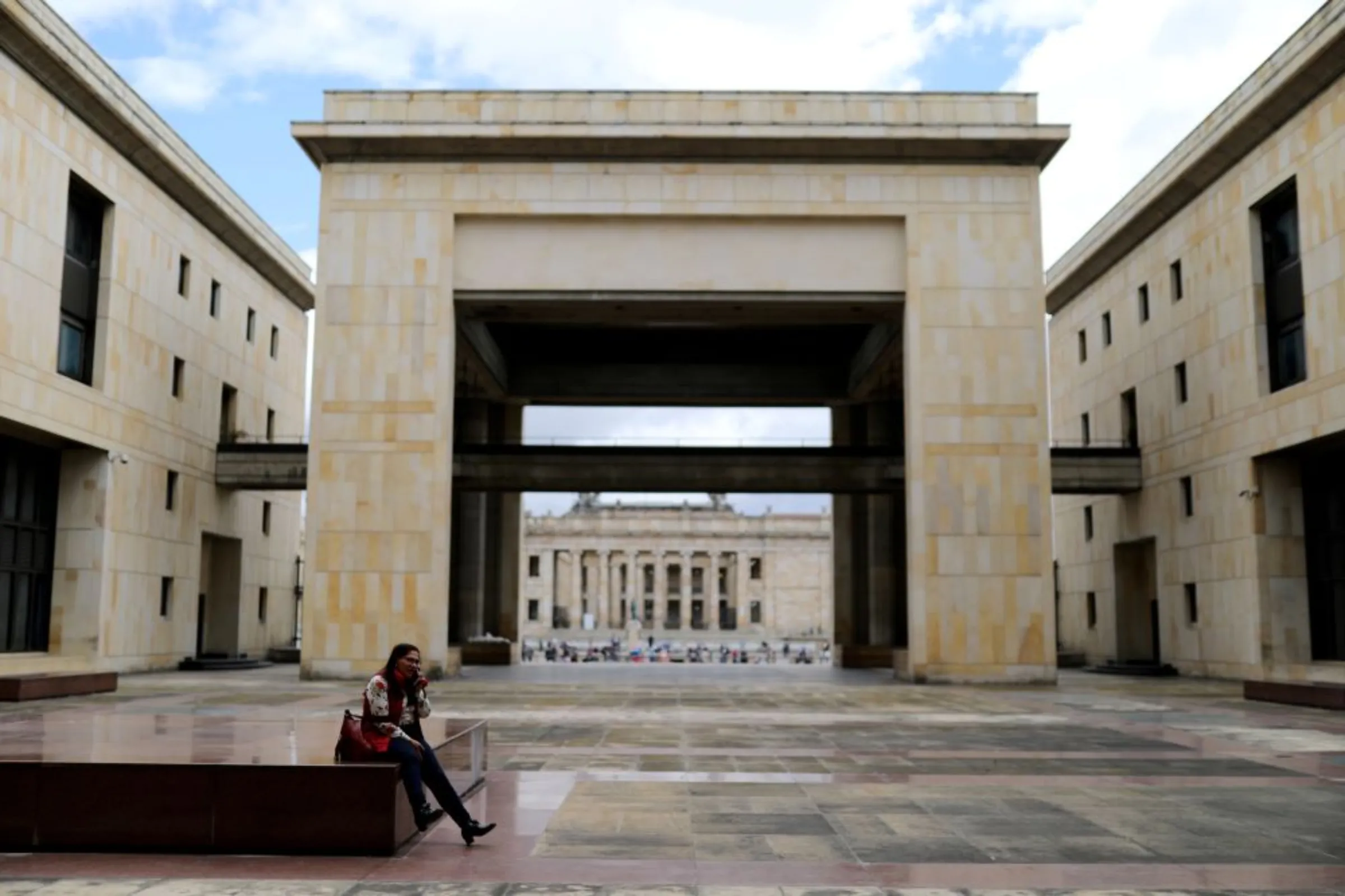 A woman speaks on a cell phone in front of the Palace of Justice building in Bogota, Colombia September 10, 2019.