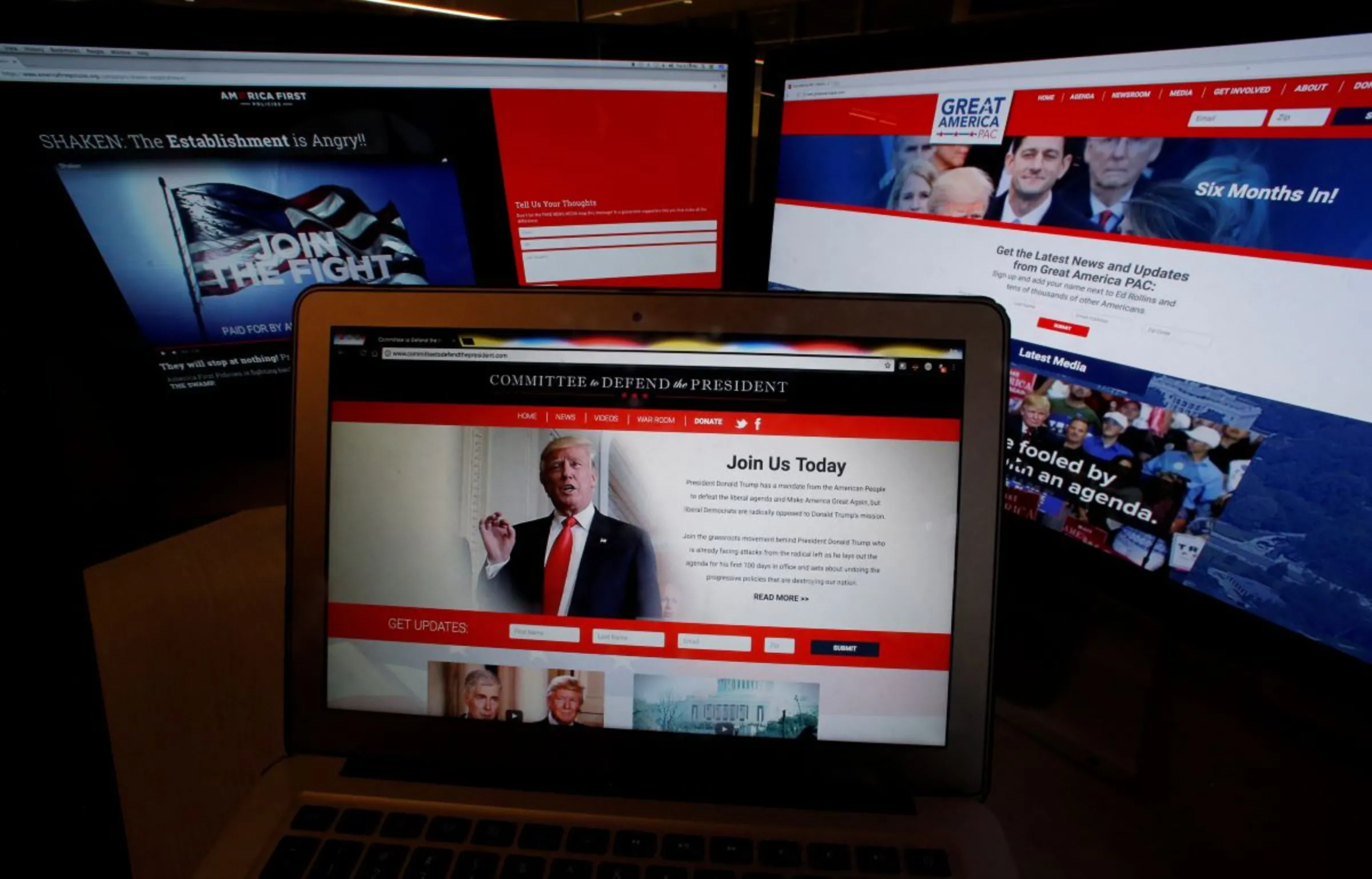 The websites of the three largest Political Action Committee (PAC) groups supporting U.S. President Donald Trump and his agenda, are seen on computer screens in this photo illustration taken in Washington, U.S., June 27, 2017