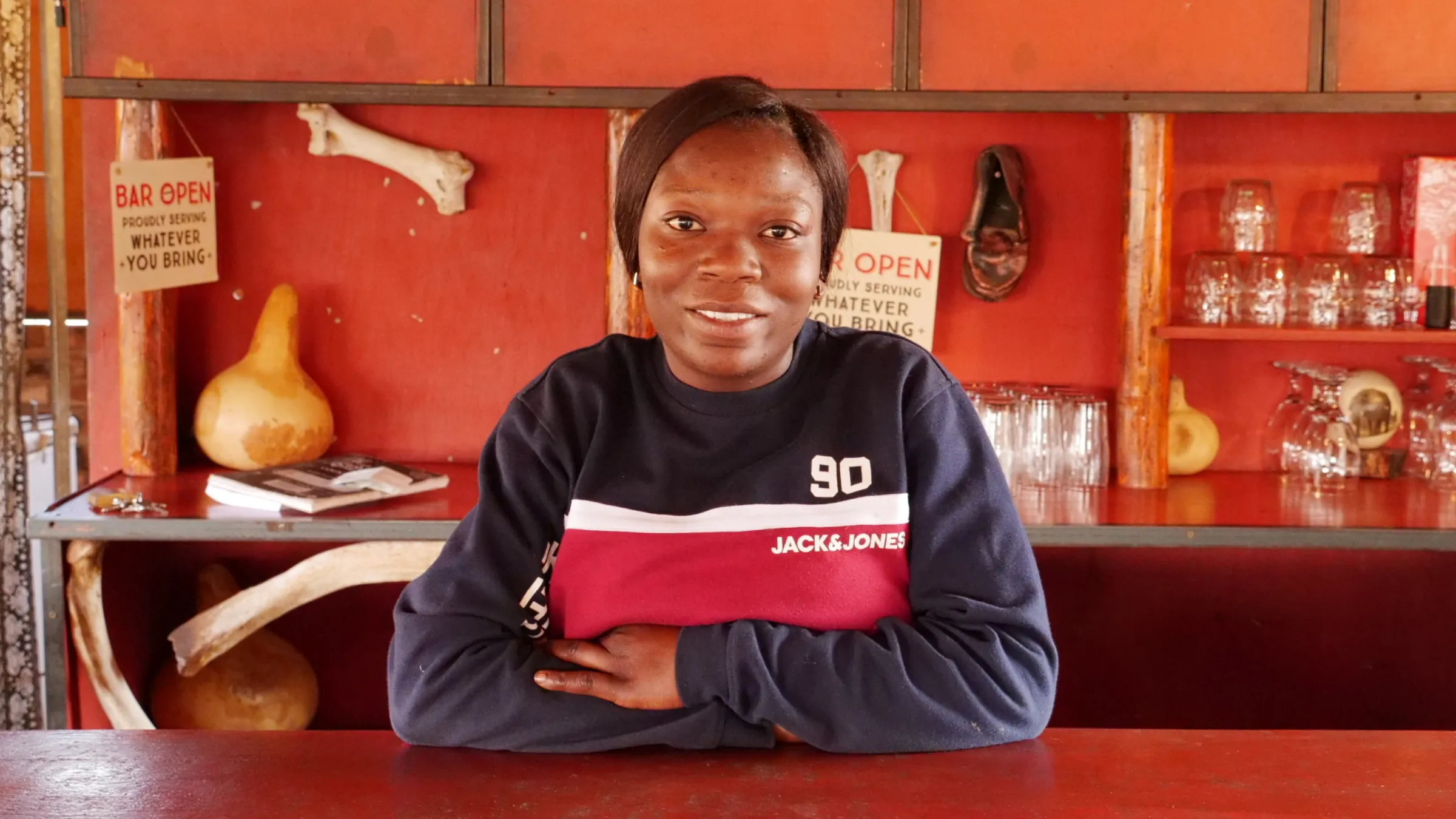 Diana Somses, a manager at a family-run campsite in Twyfelfontein, poses for a photo at the welcome desk in north-western Namibia, September 29, 2022