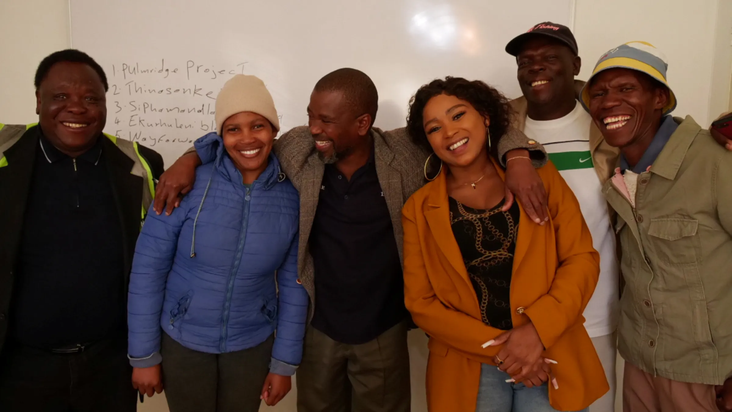 A team of data collectors smile and pose for a photo at CORC offices in in Johannesburg, South Africa, June 15, 2023. Thomson Reuters Foundation/Kim Harrisberg