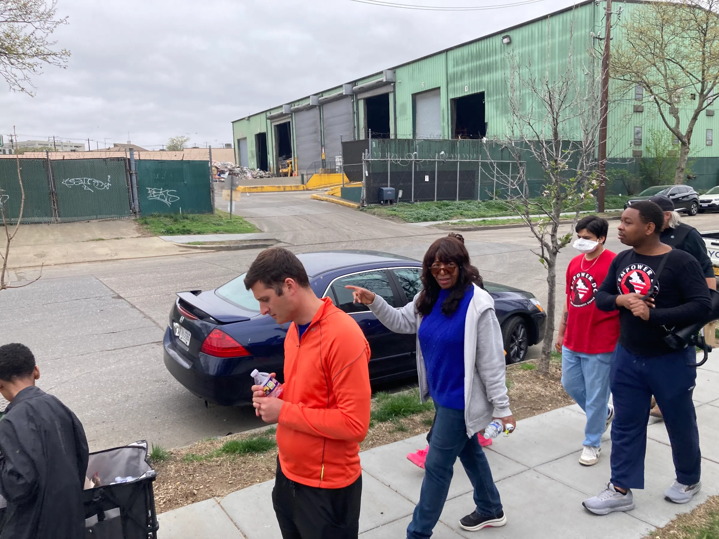 Local residents take part in an “environmental justice” tour of the Brentwood neighborhood in Washington in April 2025. Thomson Reuters Foundation/Carey L. Biron