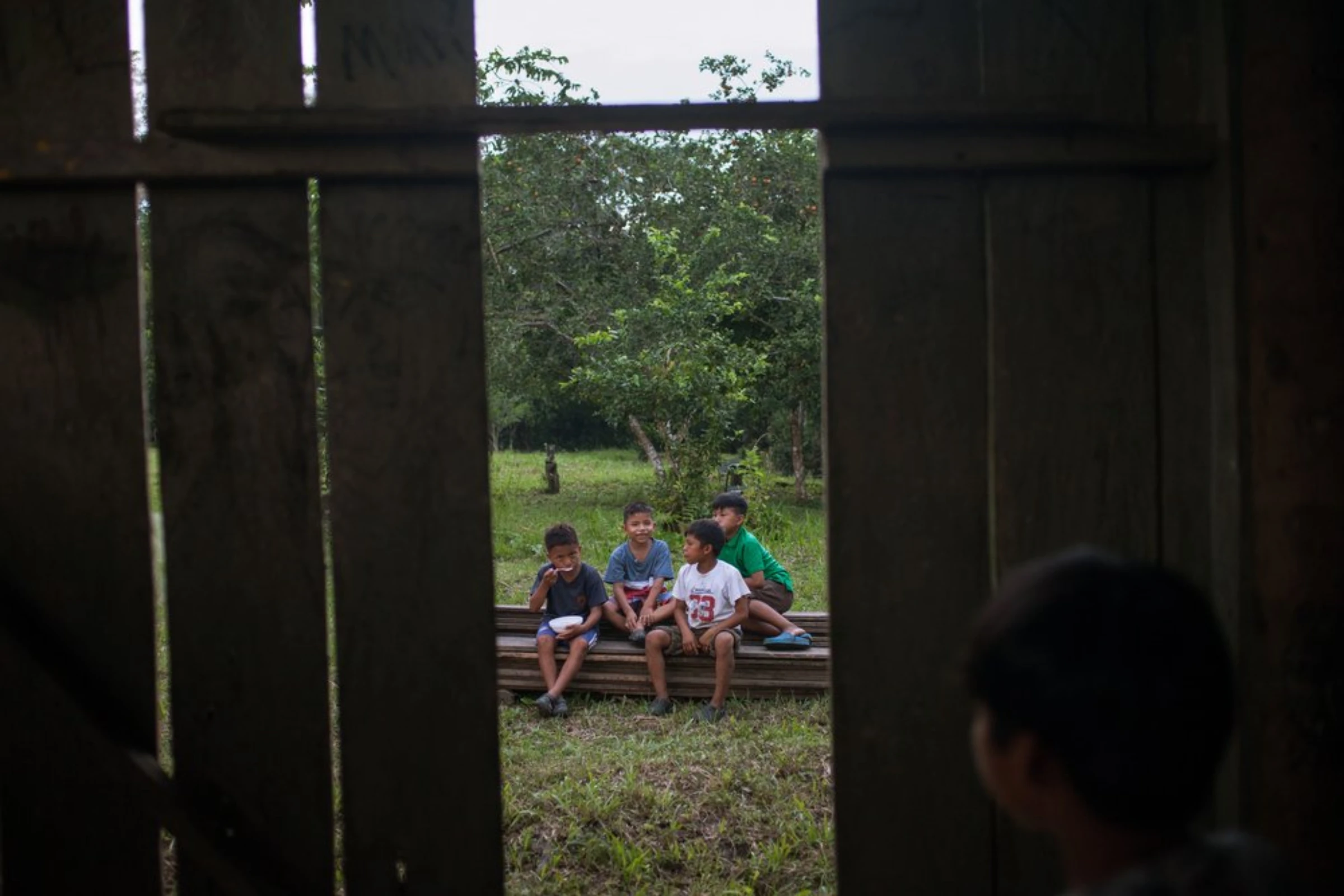 Boys from the Waorani of Pastaza indigenous group gather in their riverside village in the Amazon rainforest in the province of Pastaza, Ecuador, on April 25, 2022