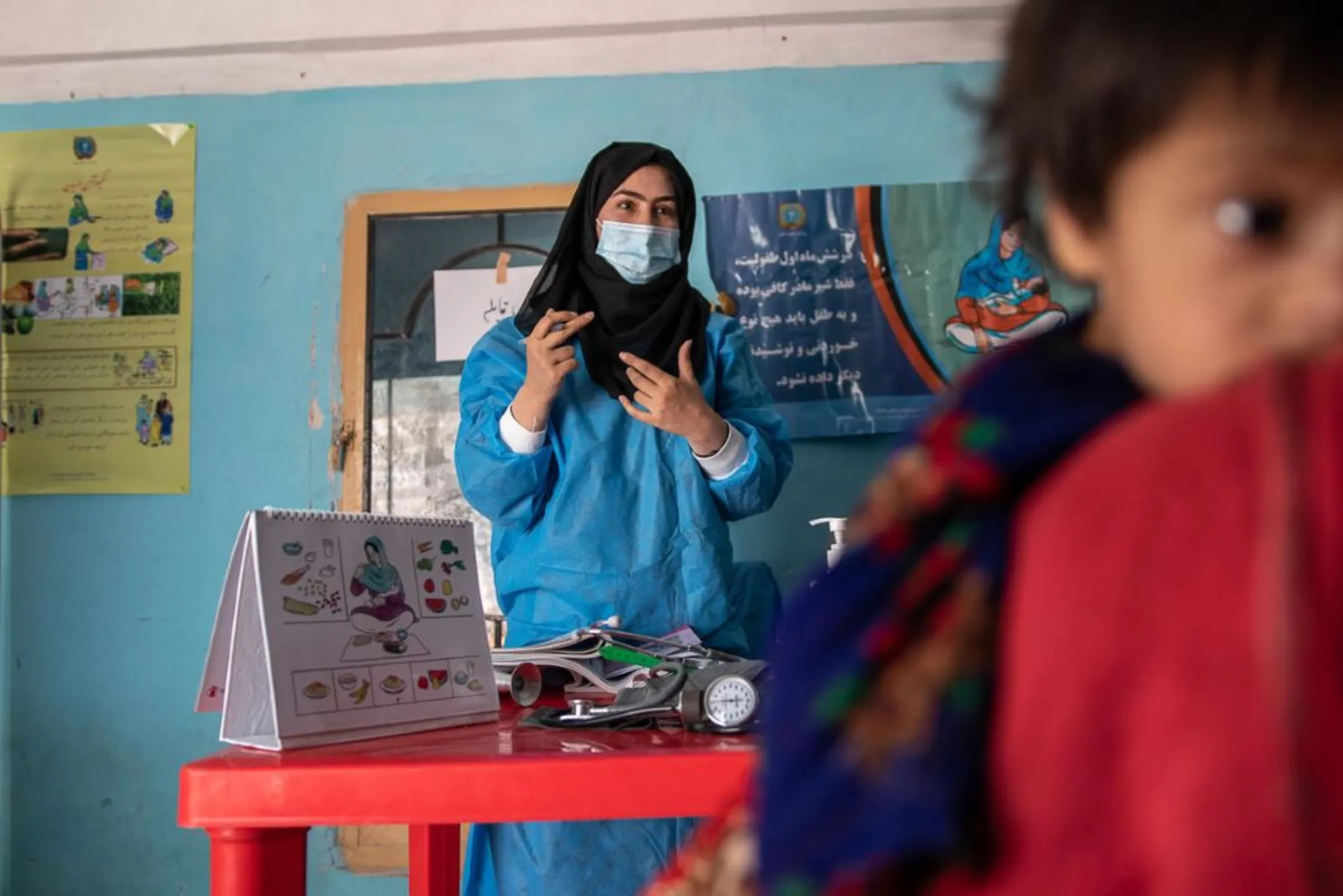 A midwife provides information to a pregnant woman during a pre-natal check-up in Jawzjan province, Afghanistan, October 2, 2022