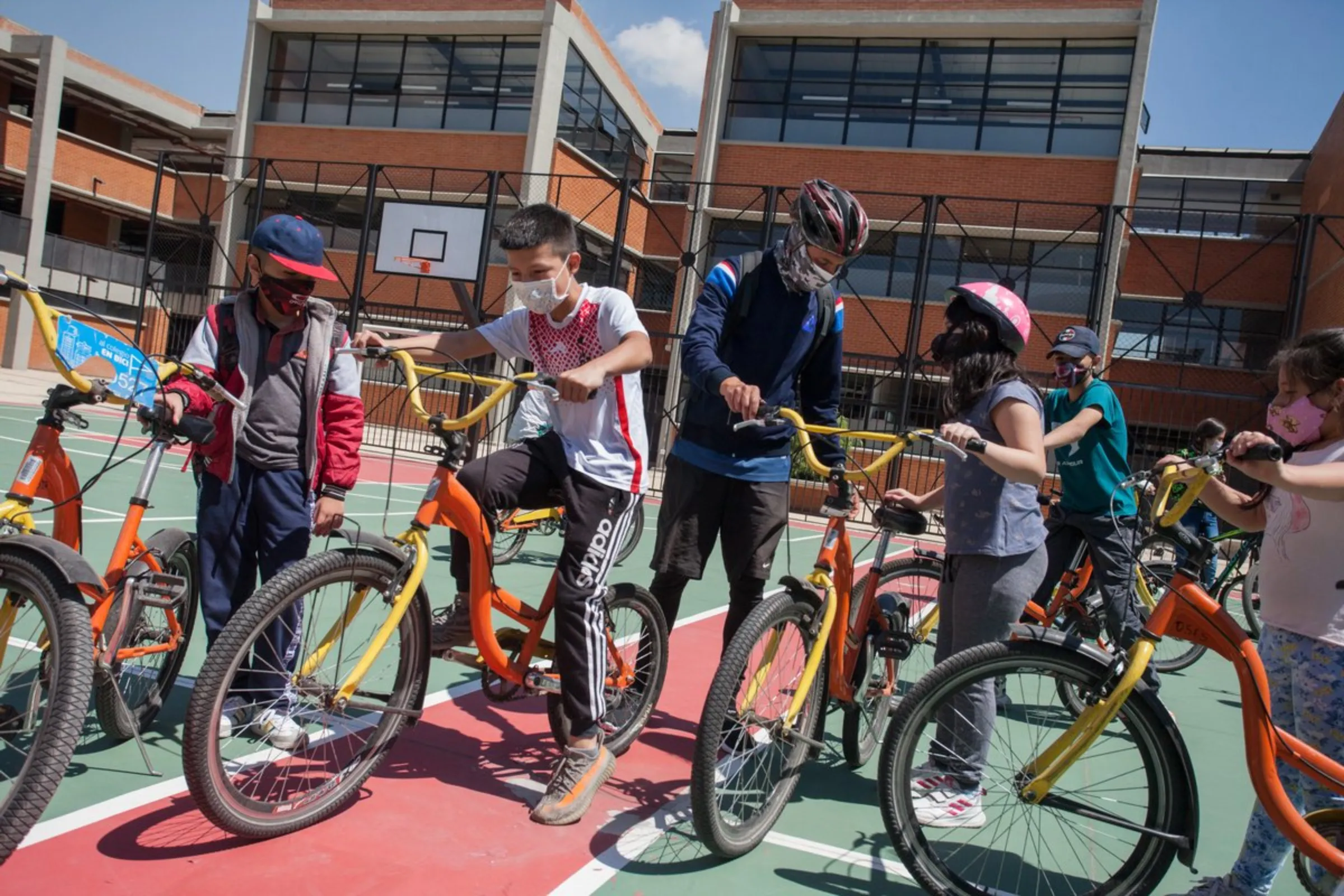 Students at “The Bike College”, a new public school in the poor neighbourhood of Bosa, prepare to ride their bicycles at the school grounds in south Bogota, Colombia, April 22, 2021