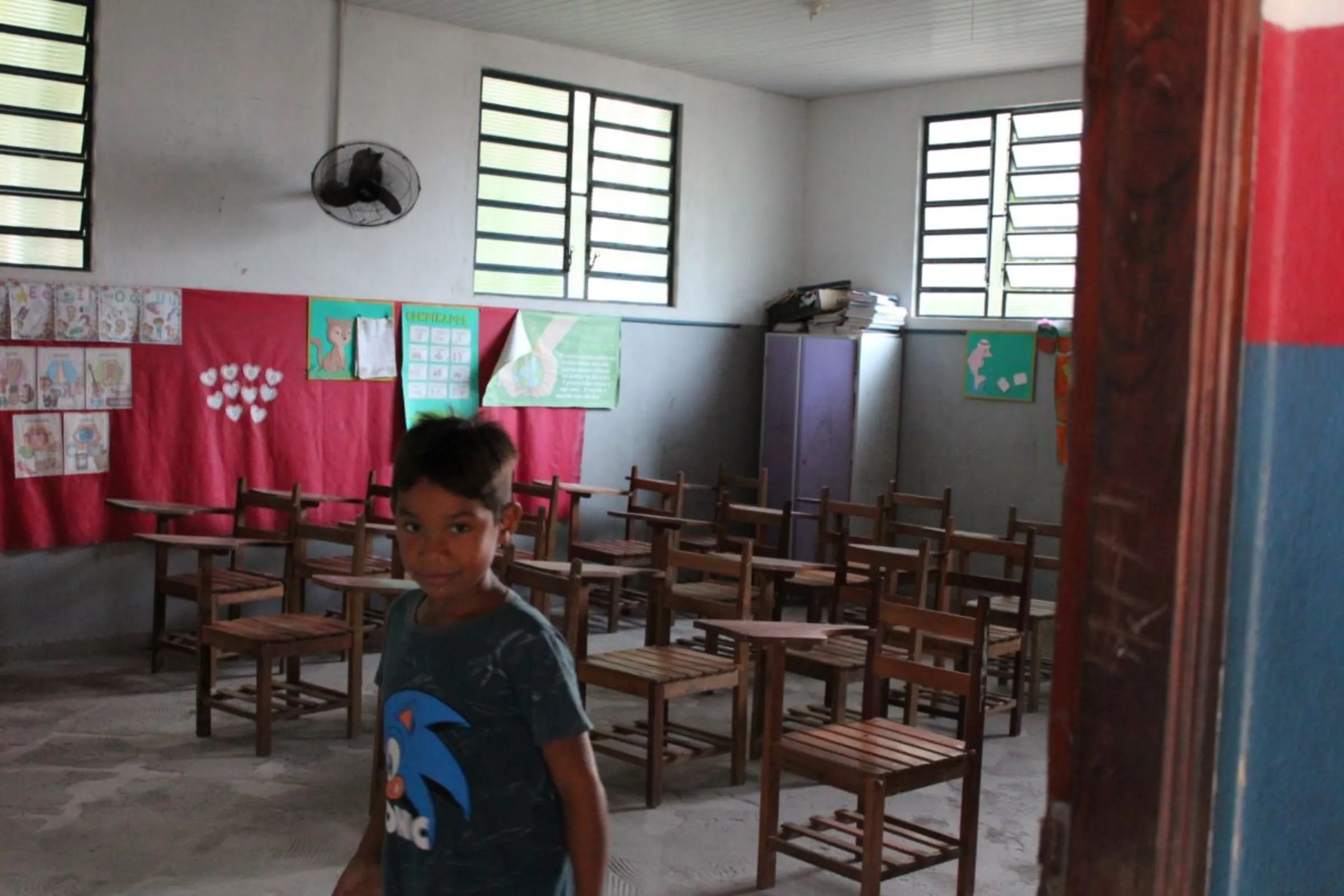 A boy in a public-school classroom on Caripetuba Island, Brazil, August 10, 2023. Local communities say Cargill’s planned port will badly impact them. Thomson Reuters Foundation /André Cabette Fábio