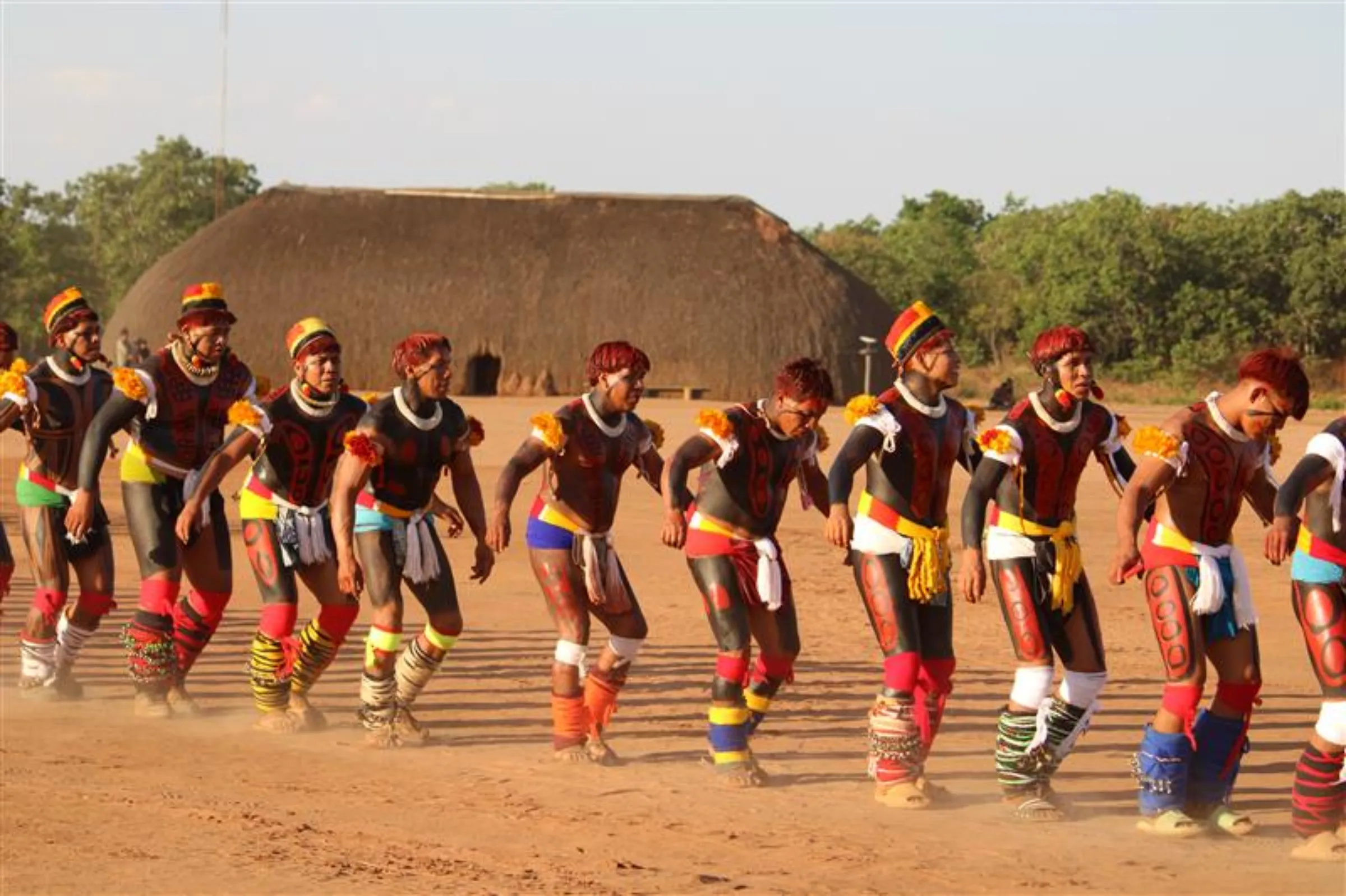 A group of men dance during the Kuarup funerary ritual in the Kalapalo people’s Tanguro village, Xingu Indigenous Park, Brazil, August 29, 2025. THOMSON REUTERS FOUNDATION/André Cabette Fábio