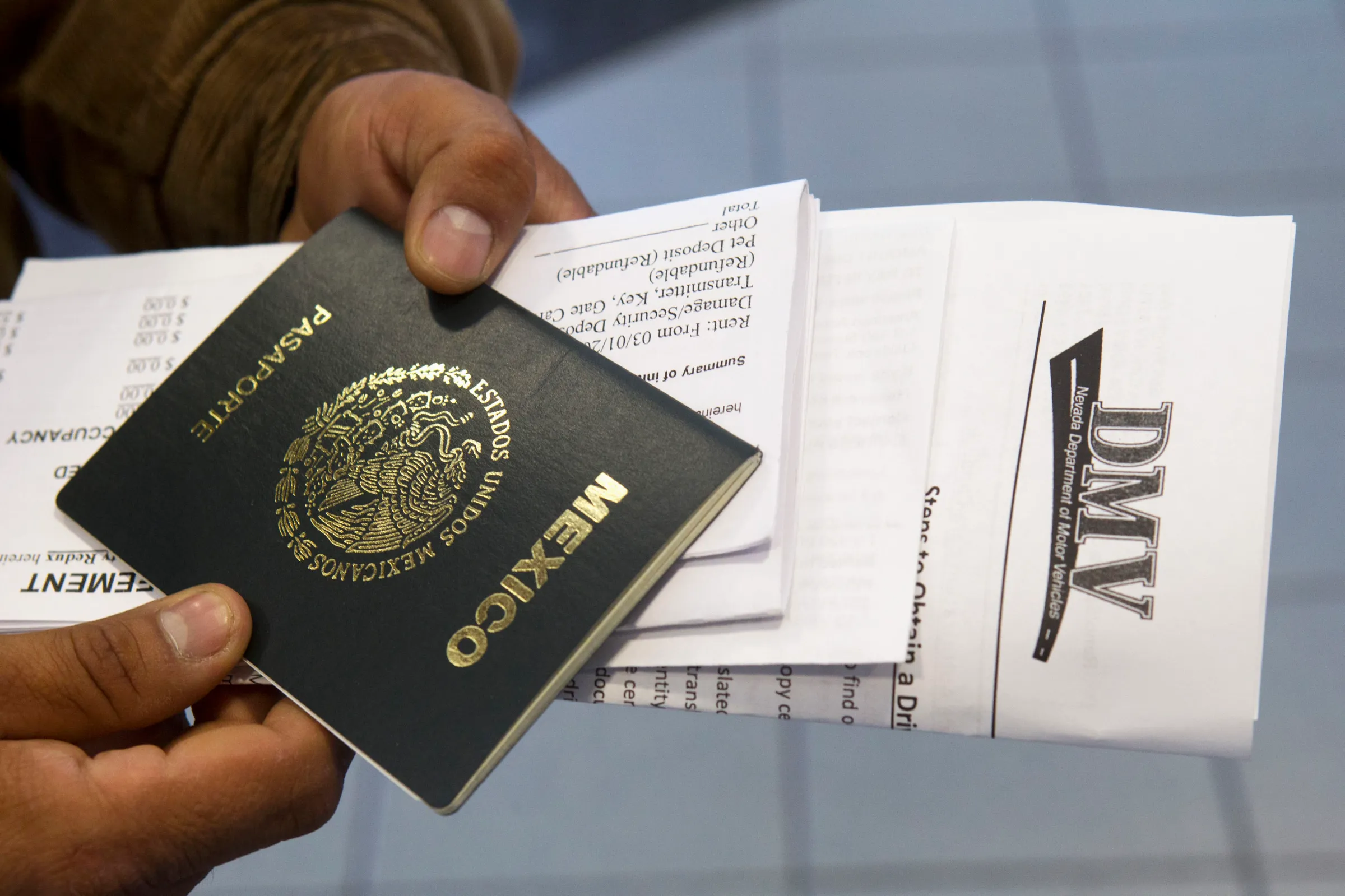 A Mexican national holds his passport in Las Vegas, Nevada January 2, 2014. REUTERS/Las Vegas Sun/Steve Marcus