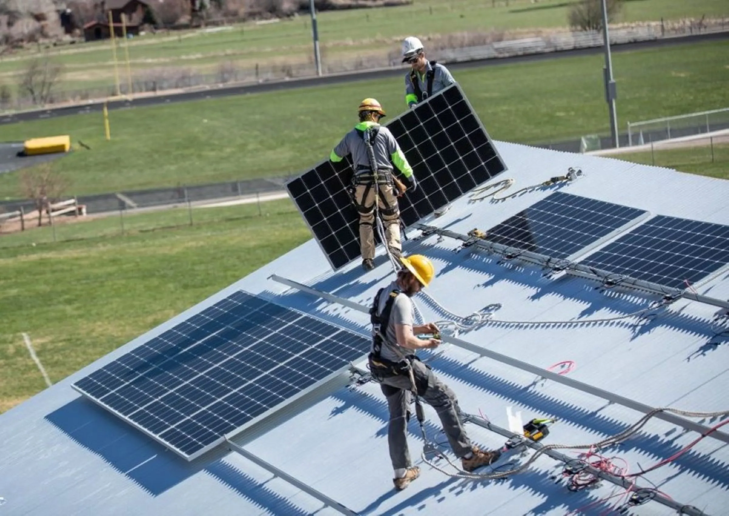 Workers in stall solar panels on a home in Basalt, Colorado, in June 2022. Holy Cross Energy/Handout via Thomson Reuters Foundation