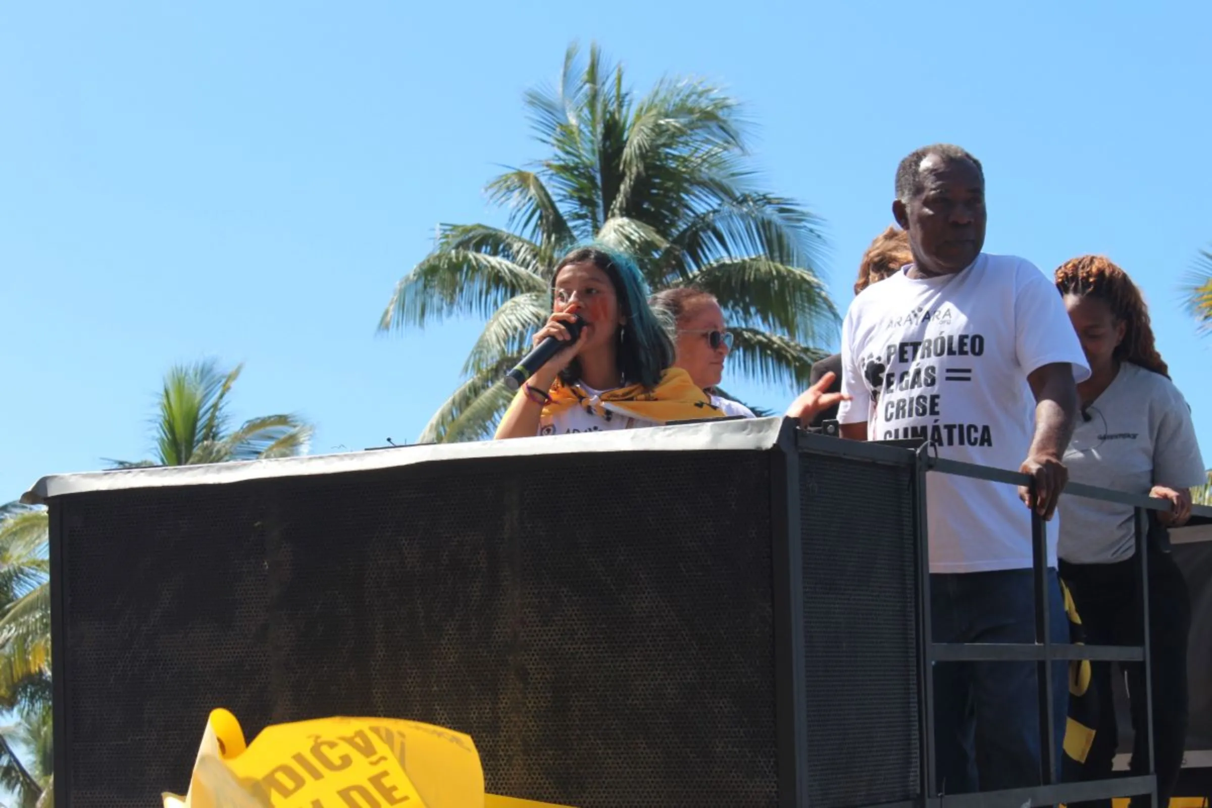 A Brazilian activist gives a speech in front of the hotel where Brazil’s government held an auction for oil and gas concession areas in Rio de Janeiro on Dec. 13, 2023. Thomson Reuters Foundation /André Cabette Fábio