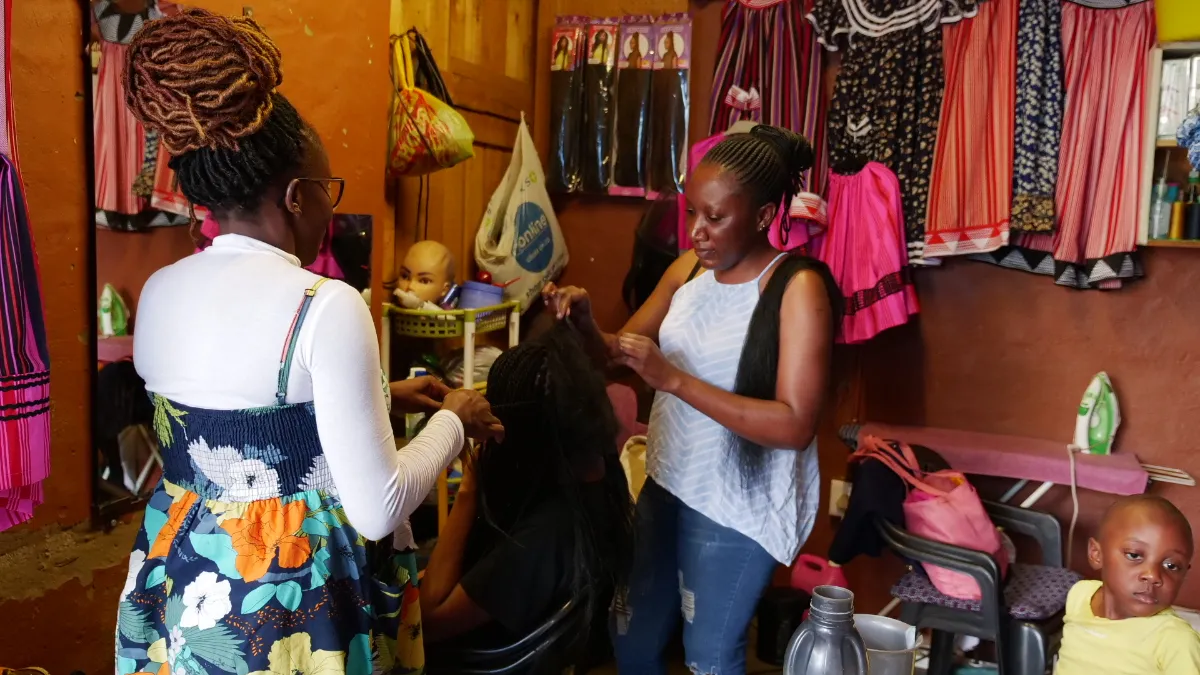 Ruusa Shikwanyu braids a clients hair in the Horse Shoe Market in Windhoek, Namibia, September, 24, 2022
