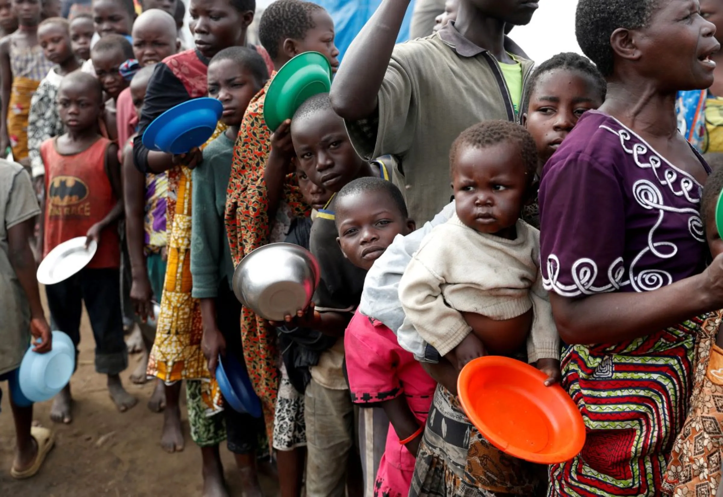 Internally displaced people wait for food distribution at an internally displaced persons (IDP) camp in Bunia, Ituri province, eastern Democratic Republic of Congo, April 12, 2018
