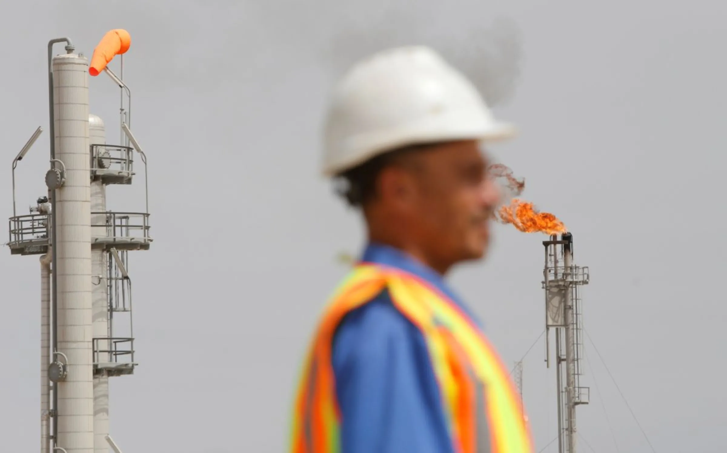 A flame burning off excess gas rises at the gas field of Siba in Basra , Iraq April 25, 2018