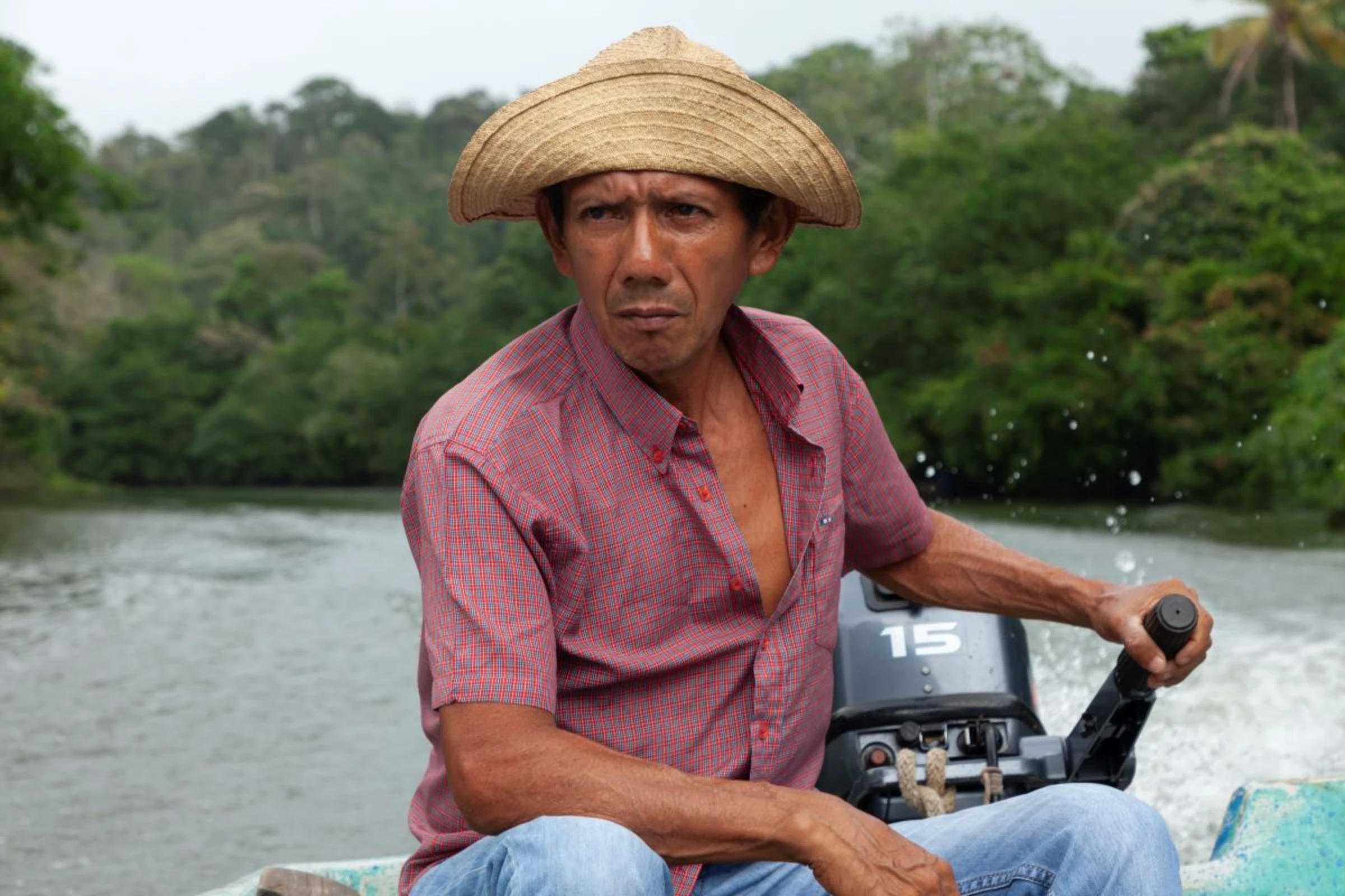 River Indio Bajo community leader, Bolivar Sanchez, rides along the River Indio, Panama, February 16, 2024. Thomson Reuters Foundation/Enea Lebrun.
