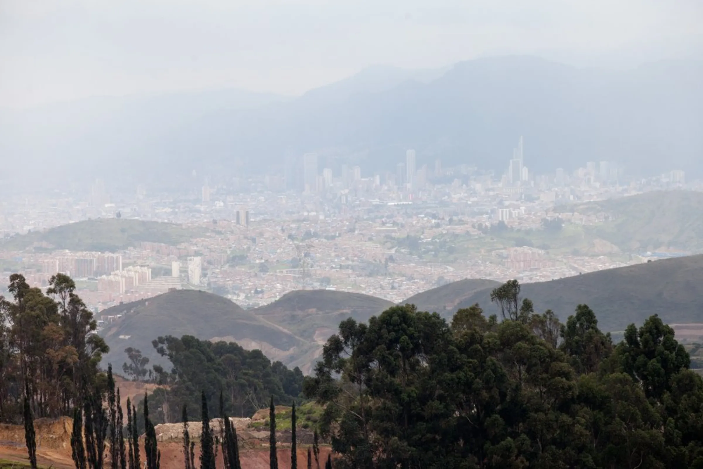 A haze of air pollution lies over the city of Bogota, Colombia, April 29, 2021