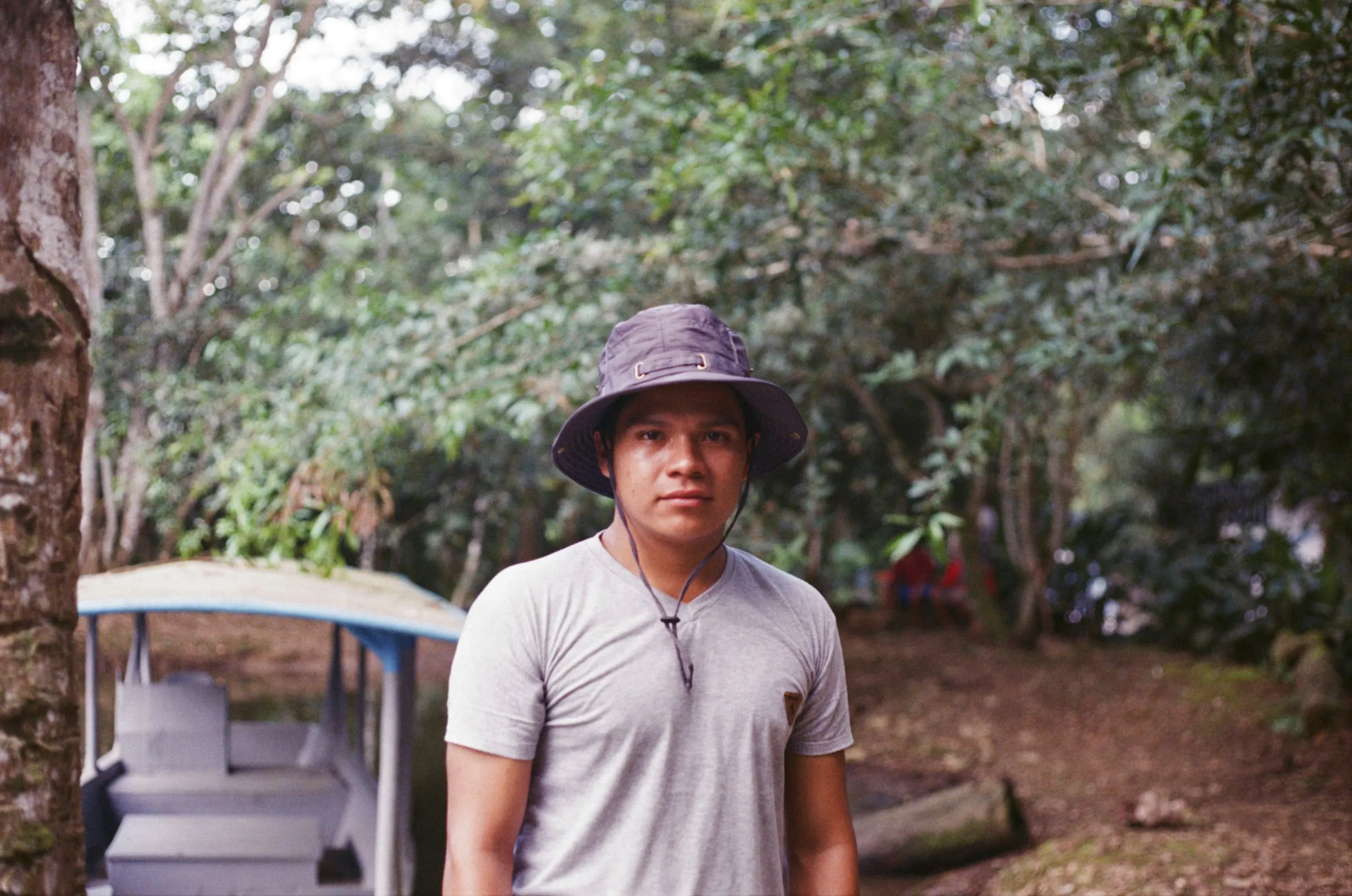 Oscar Mukucham, 22, an Achuar indigenous technician for Kara Solar, stands next to a new solar-panel-powered boat