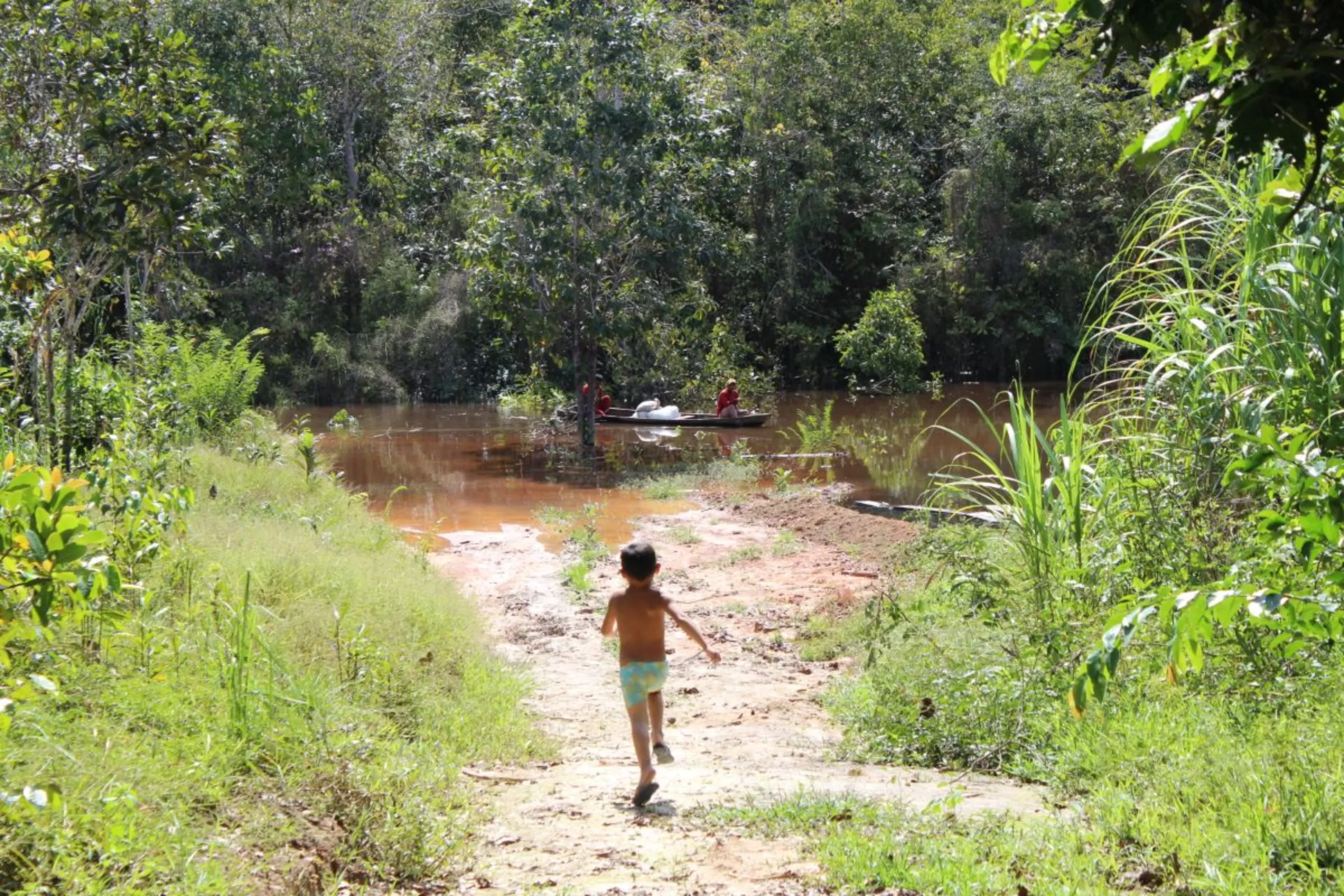 A boy runs towards the river in Pirapitinga, near Humaitá, Brazil, Feb. 28, 2024. Thomson Reuters Foundation/André Cabette Fábio