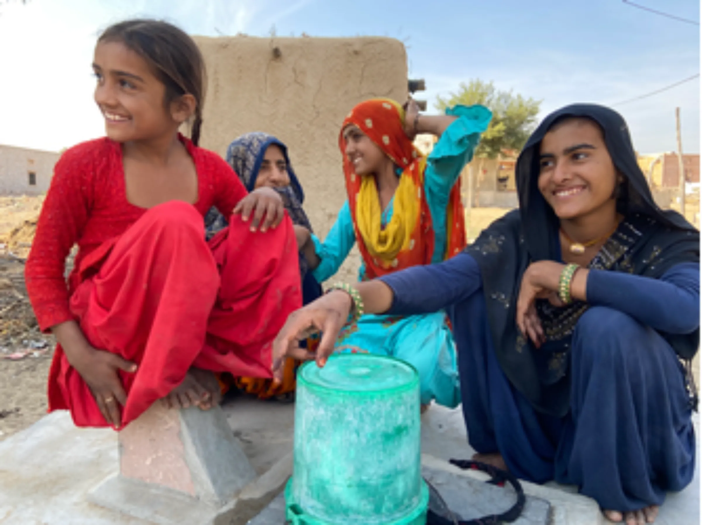 Young girls gather around the village well at Bhadla, India, on December 11, 2021. Thomson Reuters Foundation/Roli Srivastava