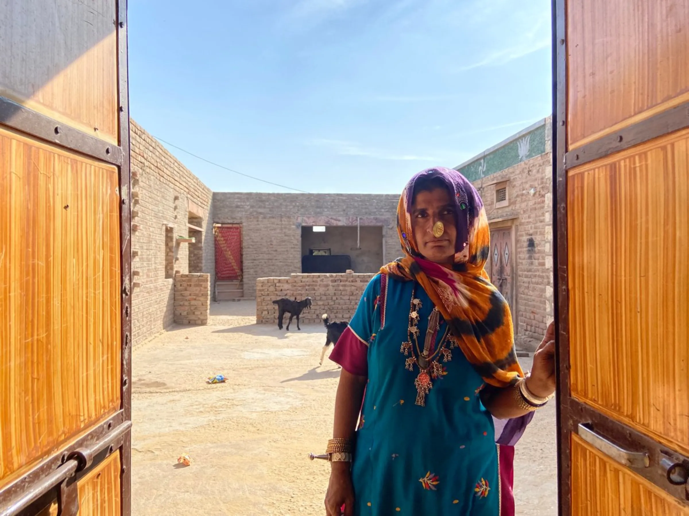 Dadda Khatoon poses for a picture at the door of her house in Bhadla village, Rajasthan, India, December 11, 2021