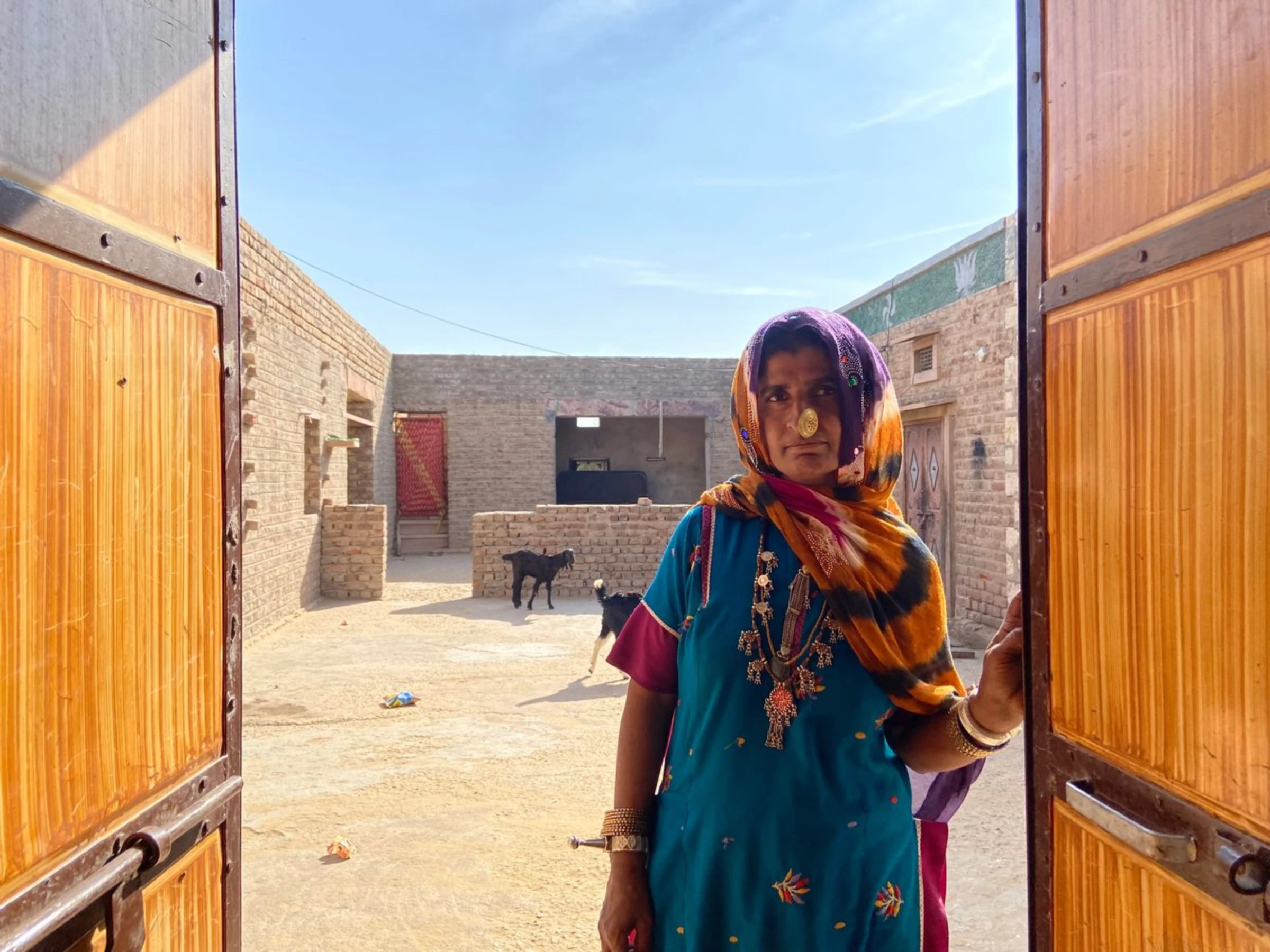 Dadda Khatoon poses for a picture at the door of her house in Bhadla village, Rajasthan, India, December 11, 2021
