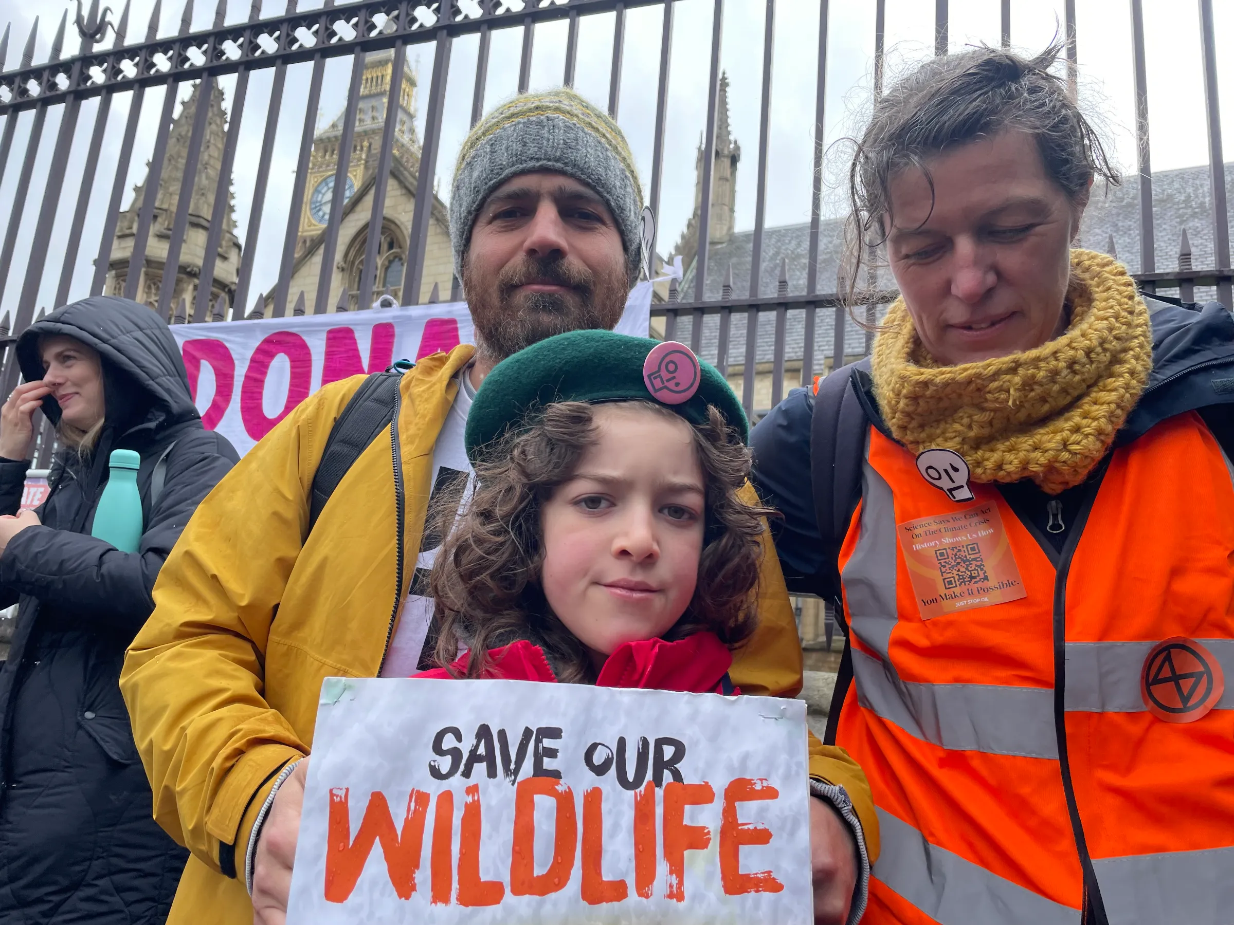 Family members Dan Mifsud, Ezra Mifsud and Sophy Allen join “The Big One”, a protest organised by Extinction Rebellion outside Parliament in London on April 21, 2023. Thomson Reuters Foundation/Laurie Goering