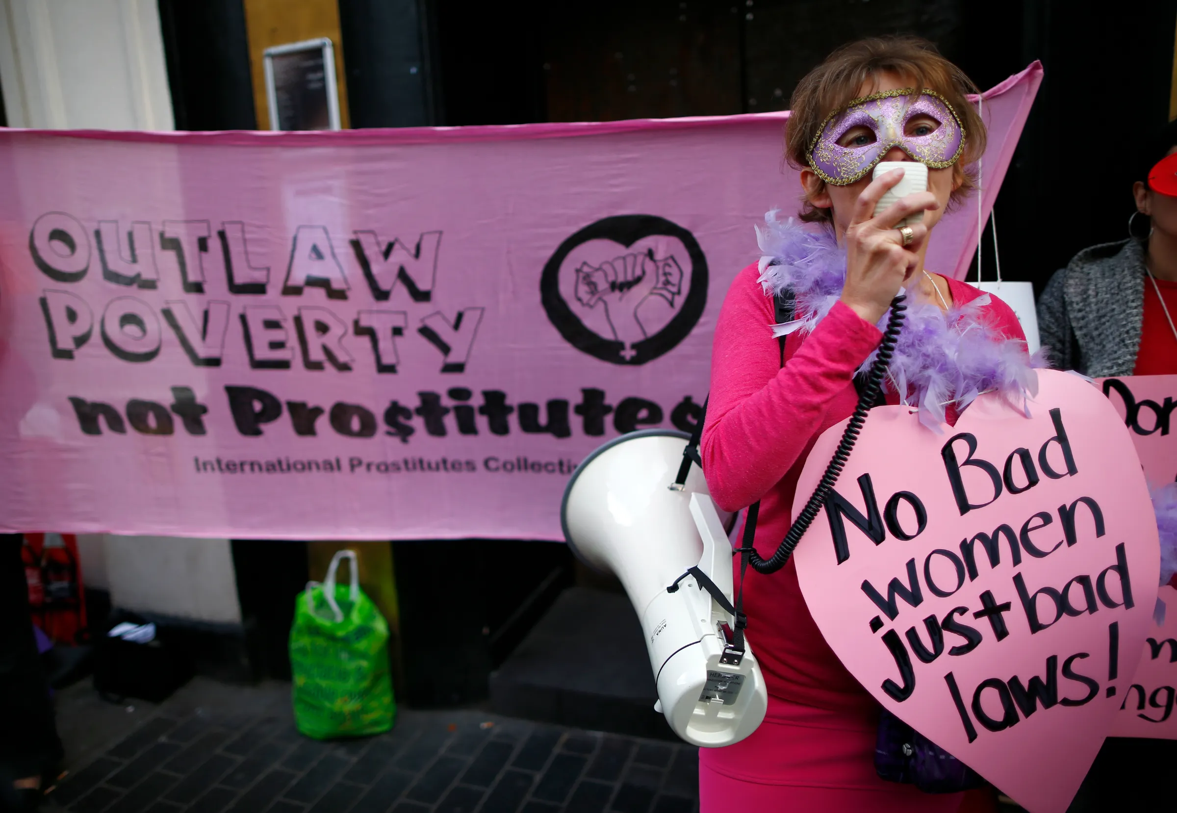 Niki Adams from the English Collective of Prostitutes, speaks through a megaphone during a demonstration at the offices of Soho estates by sex workers against the threat of eviction from a building in Soho, in central London October 9, 2013. REUTERS/Andrew Winning
