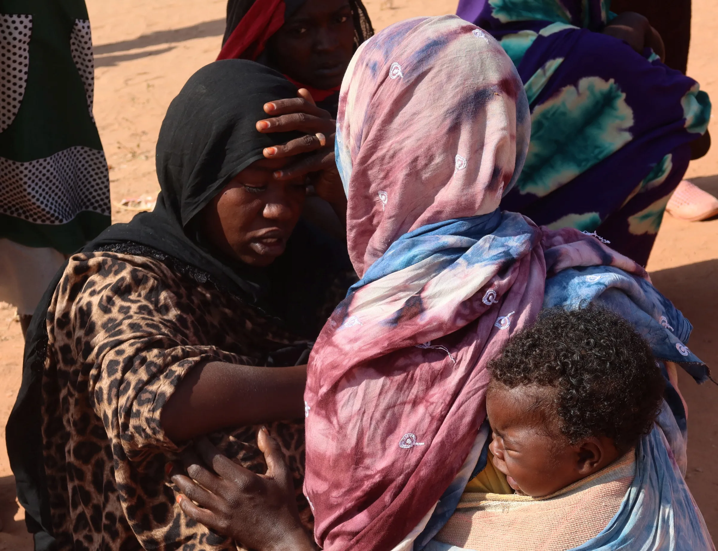 Women from El Geneina, West Darfur, await news of their missing relatives, as they gather near the border crossing in Adre, Chad, November 7, 2023. REUTERS/El Tayeb Siddig