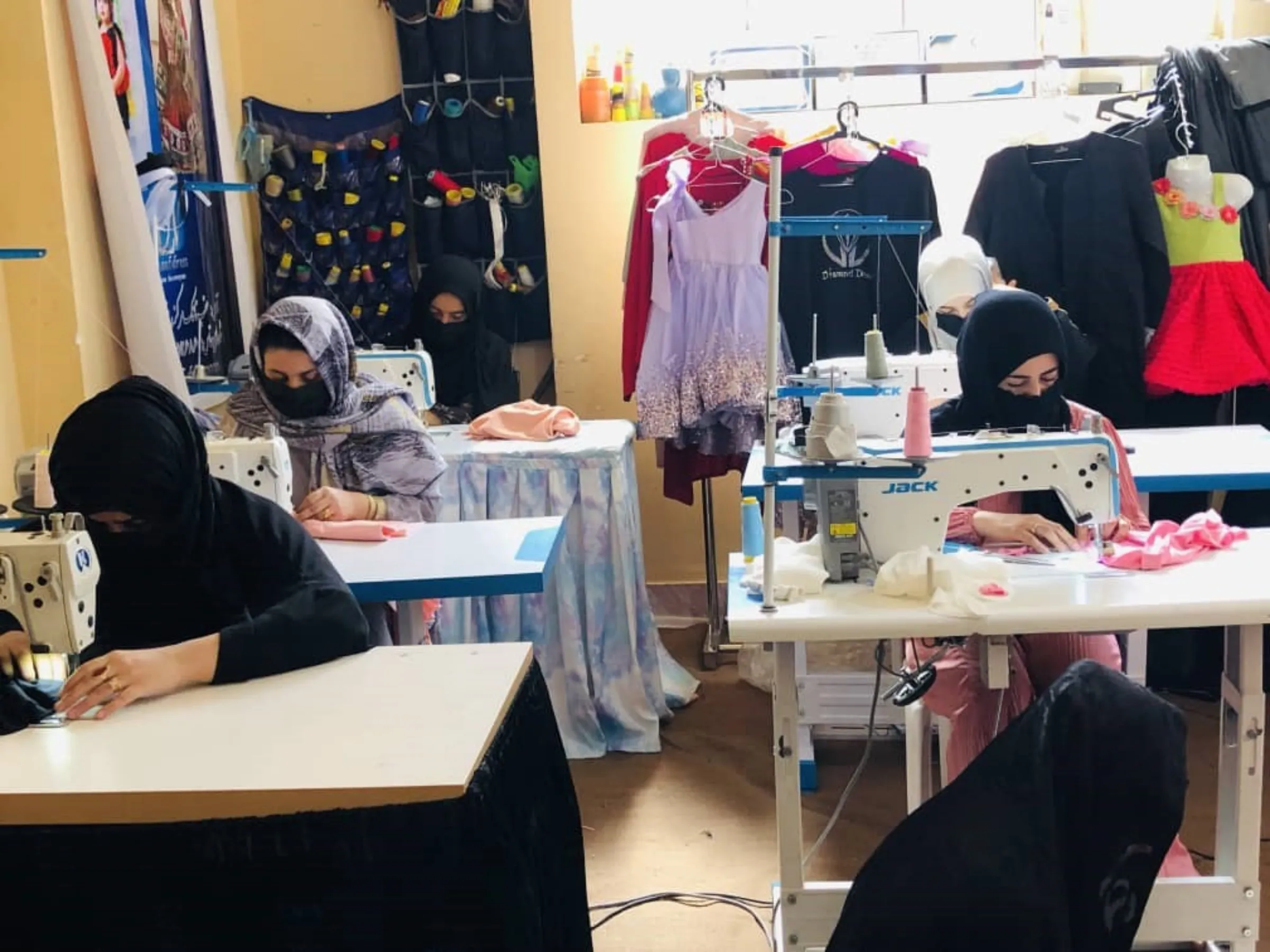 Afghan women work at Wajiha Sekhawat's tailoring studio in Herat. Photo taken August 2023. Handout/Thomson Reuters Foundation