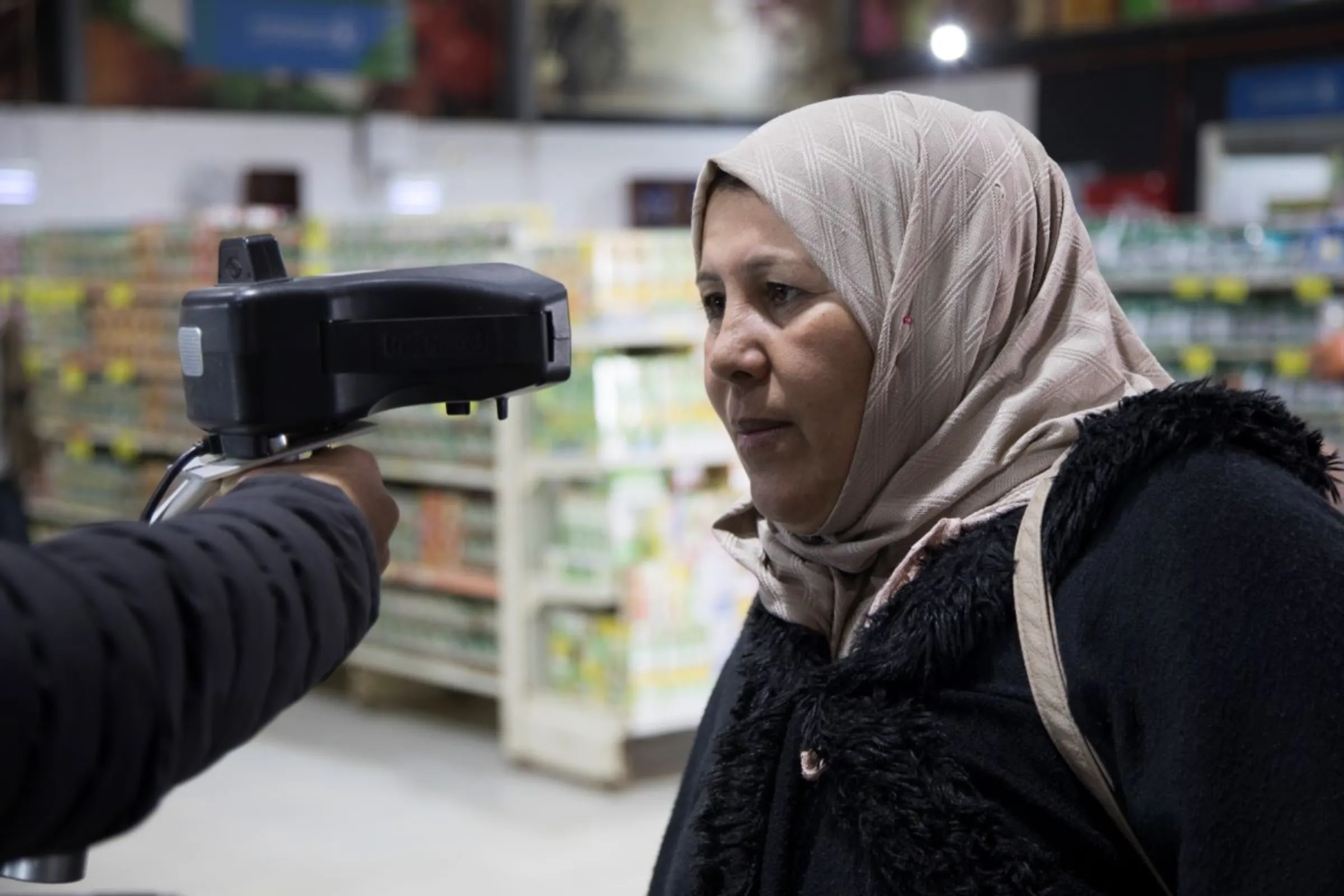 Sameera Sabbouh ,40, uses an iris scanner to pay for her grocery shopping in Sameh Mall, in Azraq, Jordan. November 27, 2022