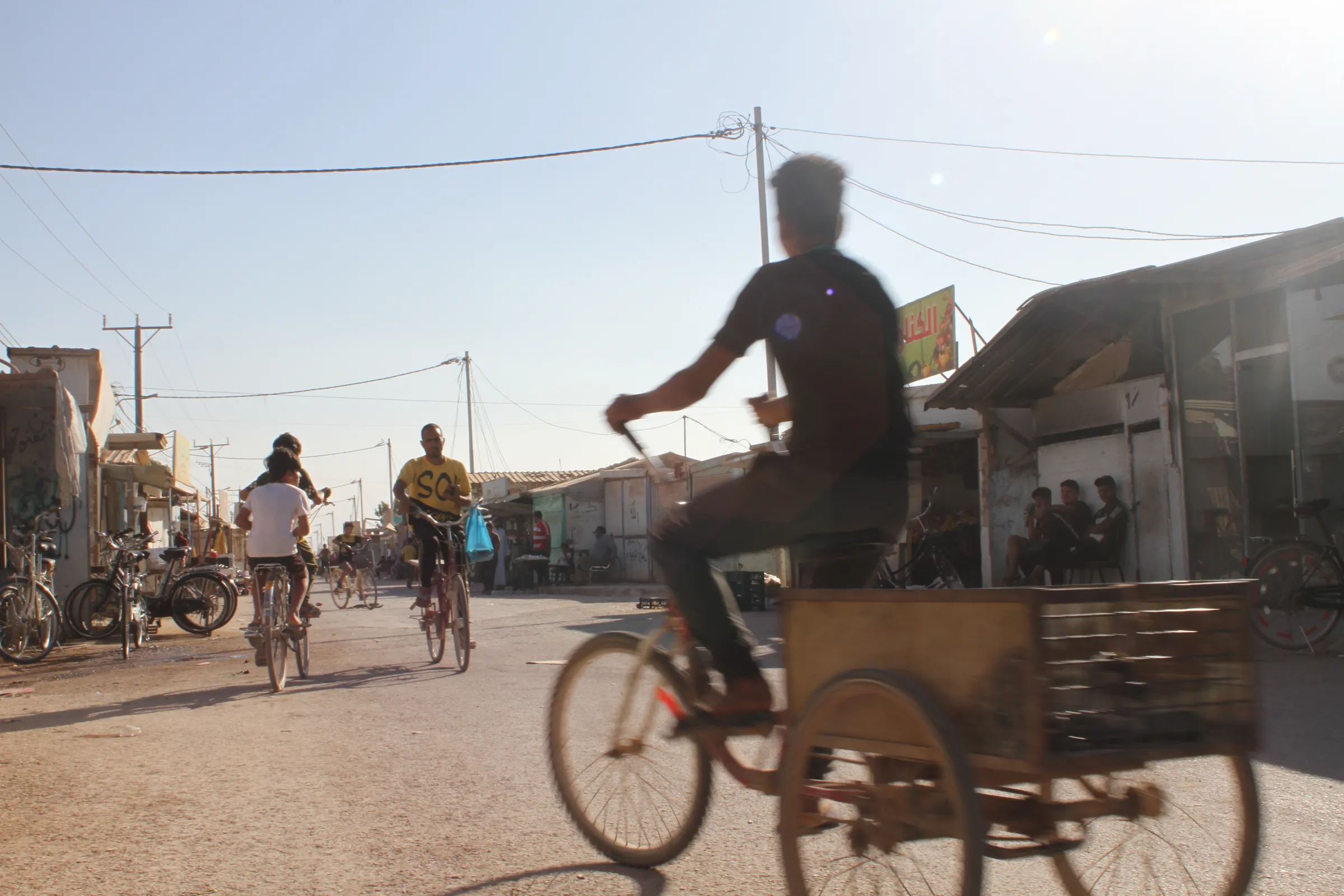 Syrian refugees ride bicycles at the Zaatari refugee camp near the border city of Mafraq, Jordan, 18 October 2022