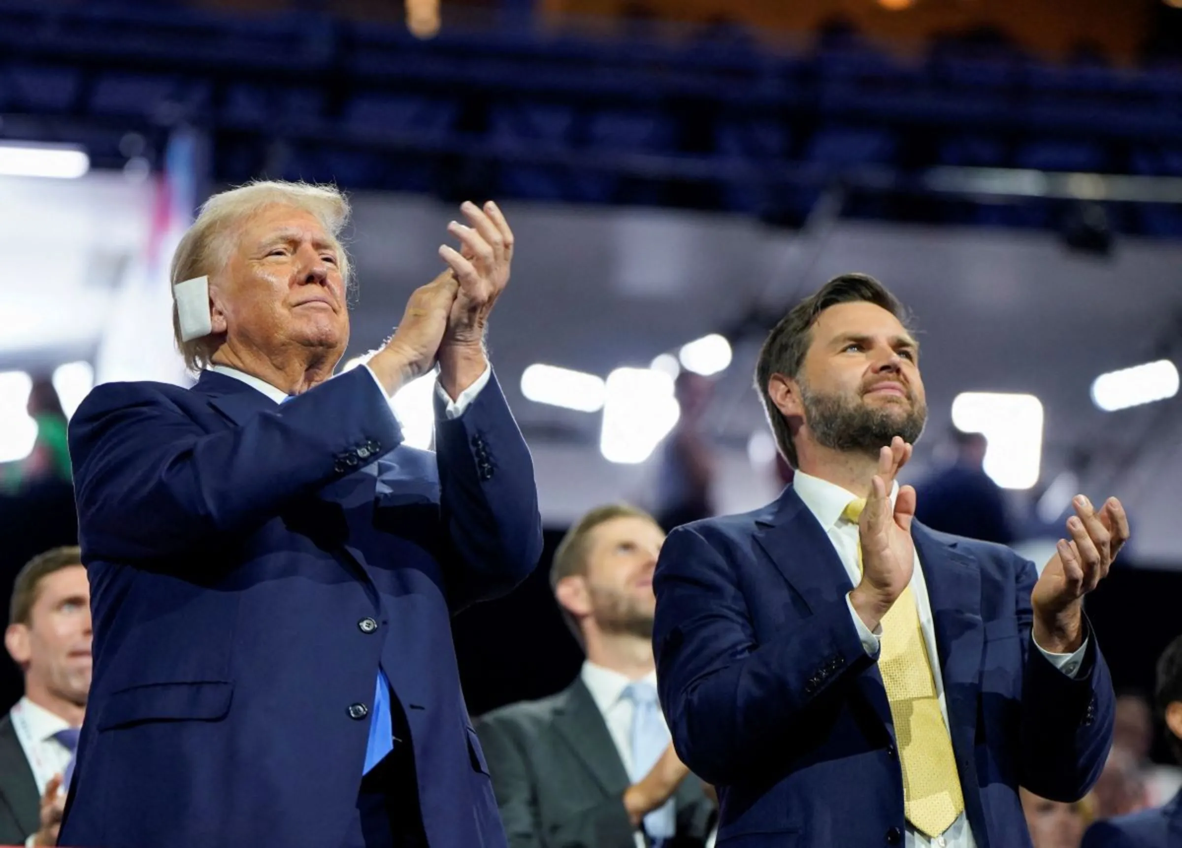 Republican presidential nominee and former U.S. President Donald Trump and Republican vice presidential nominee J.D. Vance applaud on Day 2 of the Republican National Convention (RNC), in Milwaukee, Wisconsin, U.S., July 16, 2024. REUTERS/Elizabeth Frantz
