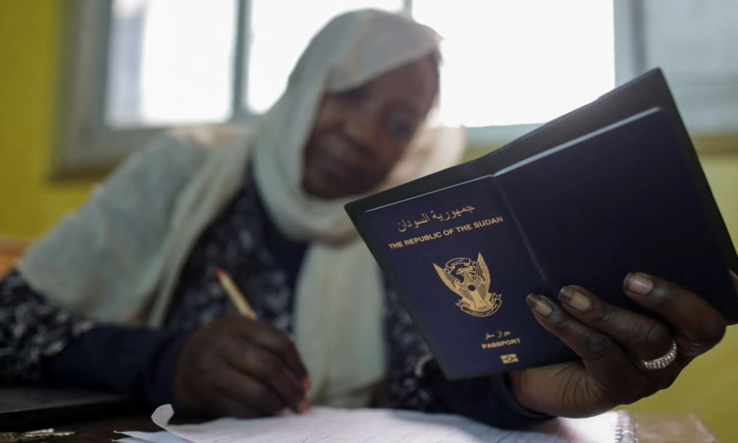 Amal Rahal, head of Amal al-Mostaqbal 'Hope for Future' initiative, checks and records documents of Sudanese displaced women, after they braved a perilous journey from war-ridden Khartoum, in the capital city of Cairo, Egypt, May 13, 2023. REUTERS/Hadeer Mahmoud