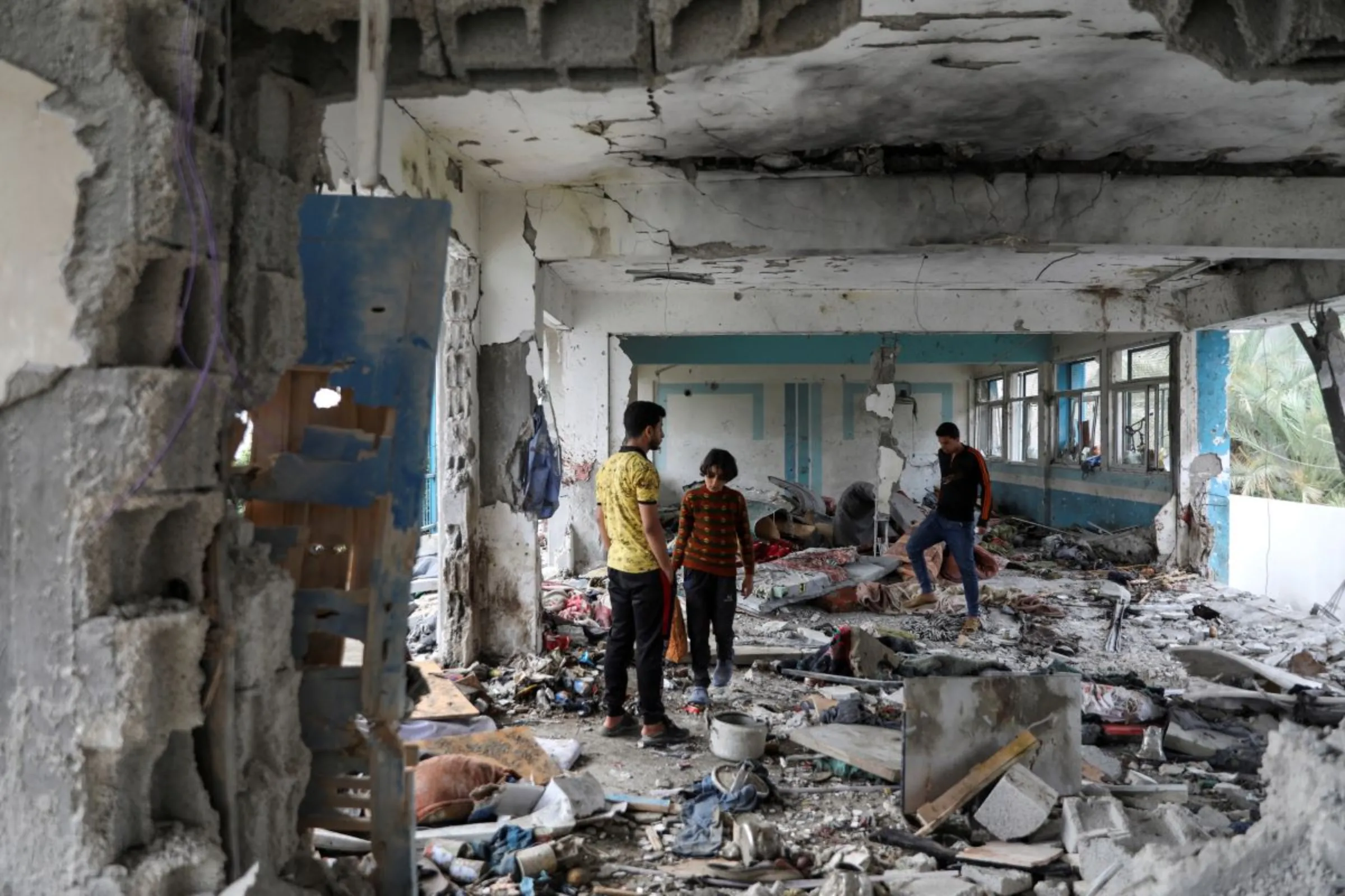 Palestinians inspect the site of an Israeli strike on a UNRWA school sheltering displaced people, amid the Israel-Hamas conflict, in Nuseirat refugee camp in the central Gaza Strip, June 6, 2024. REUTERS/Abed Khaled