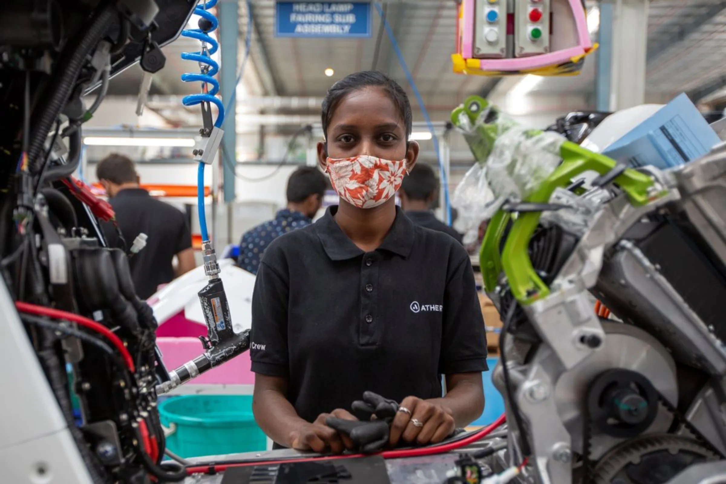 Workers assemble electric scooters at the Ather Energy factory in Hosur, India, April 20, 2022