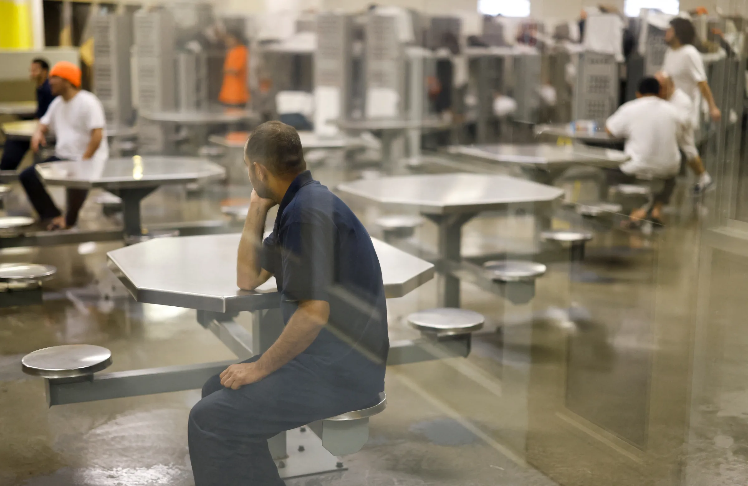 A detainee sits in a common and sleeping area at the Moshannon Valley Processing Center, a former prison repurposed as an immigration detention facility operated by the GEO Group in Philipsburg, Pennsylvania, U.S. July 27, 2023. REUTERS/Quinn Glabicki