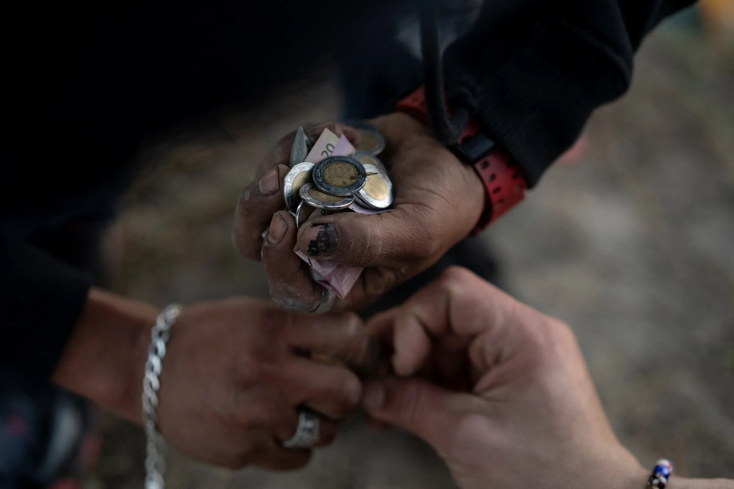 Smugglers, also known as coyotes, divide their earnings collected from migrants on Christmas morning after guiding a group across into Eagle Pass, Texas from from Piedras Negras, Coahuila, Mexico, December 25, 2023. REUTERS/Cheney Orr
