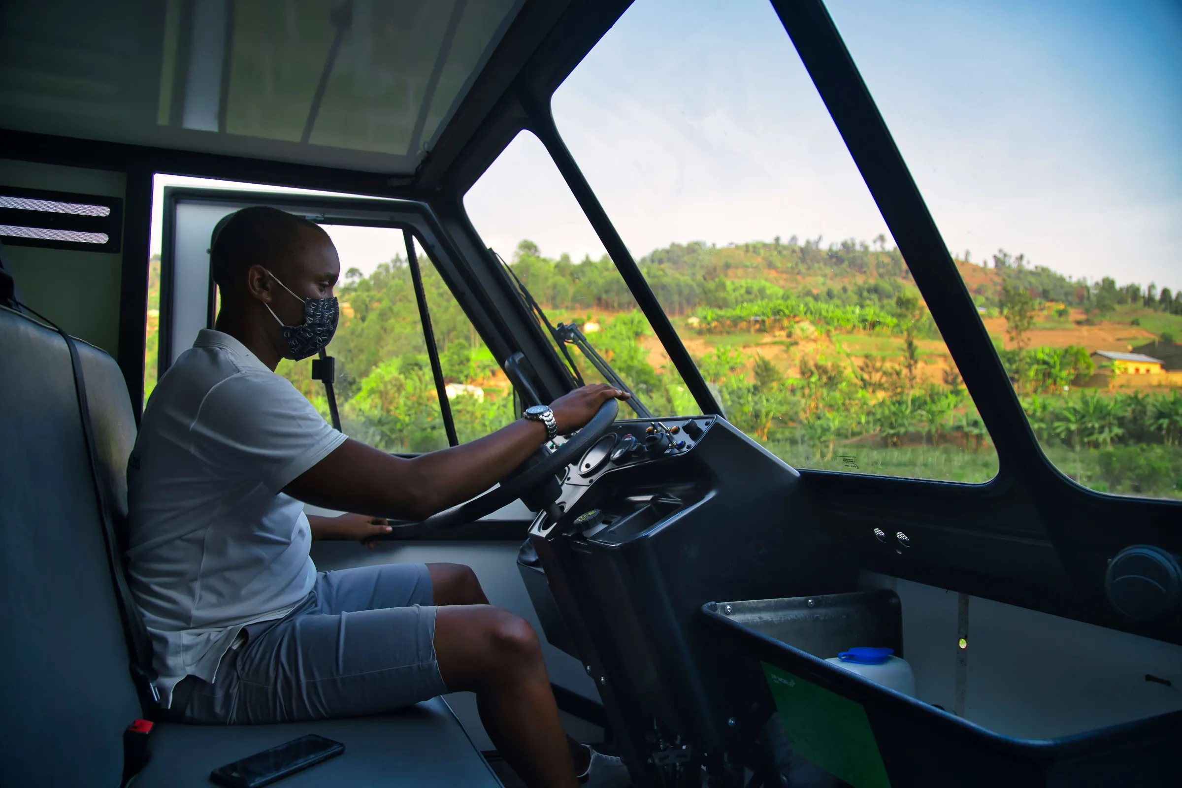 An OX driver at the wheel en route to collect an order in Nyamasheke, Rwanda. September 14, 2021. Thomson Reuters Foundation/ Handout via OX.