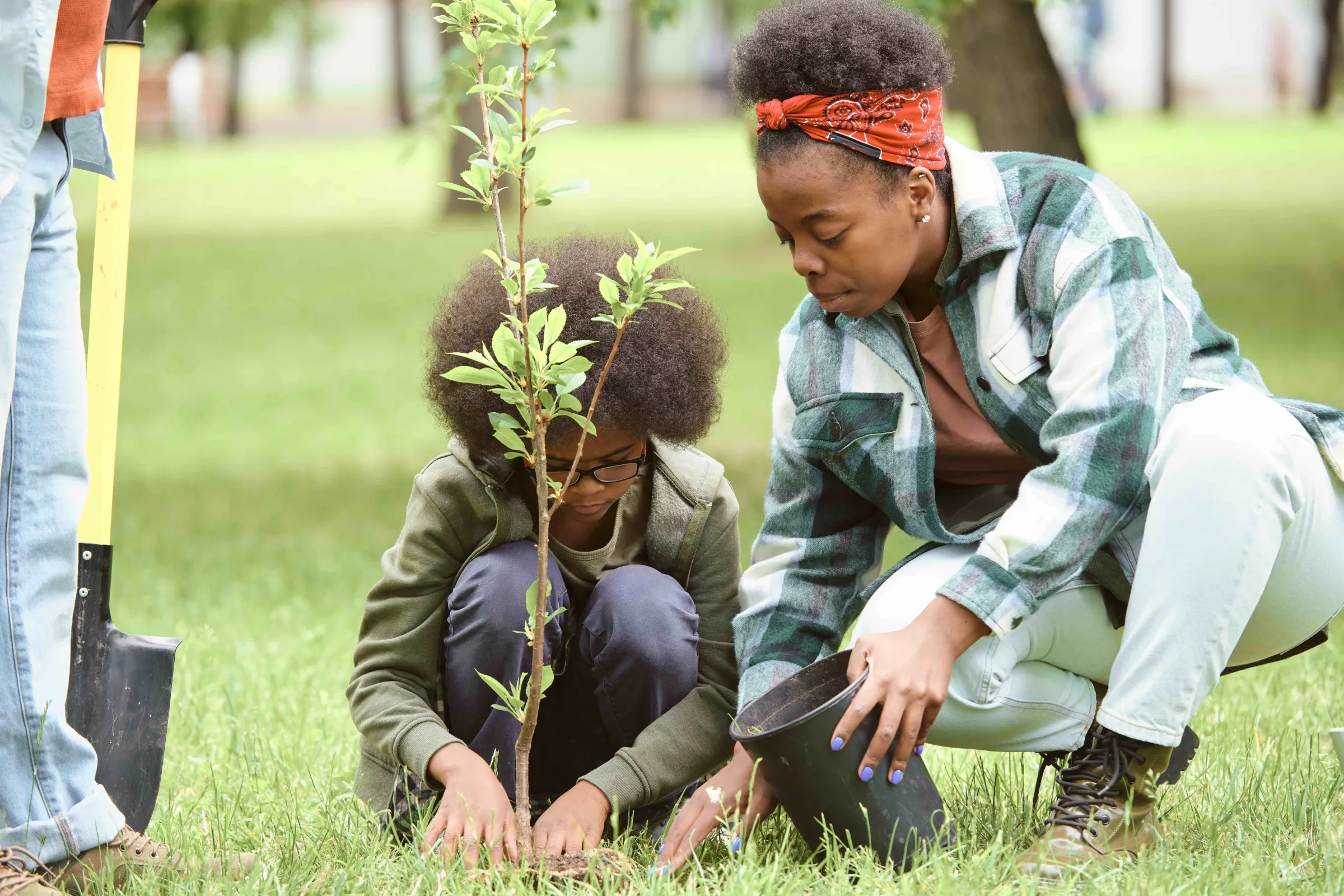 A woman and her son plant a sapling in the Southside area of Richmond, Virginia. Southside ReLeaf / Handout via Thomson Reuters Foundation