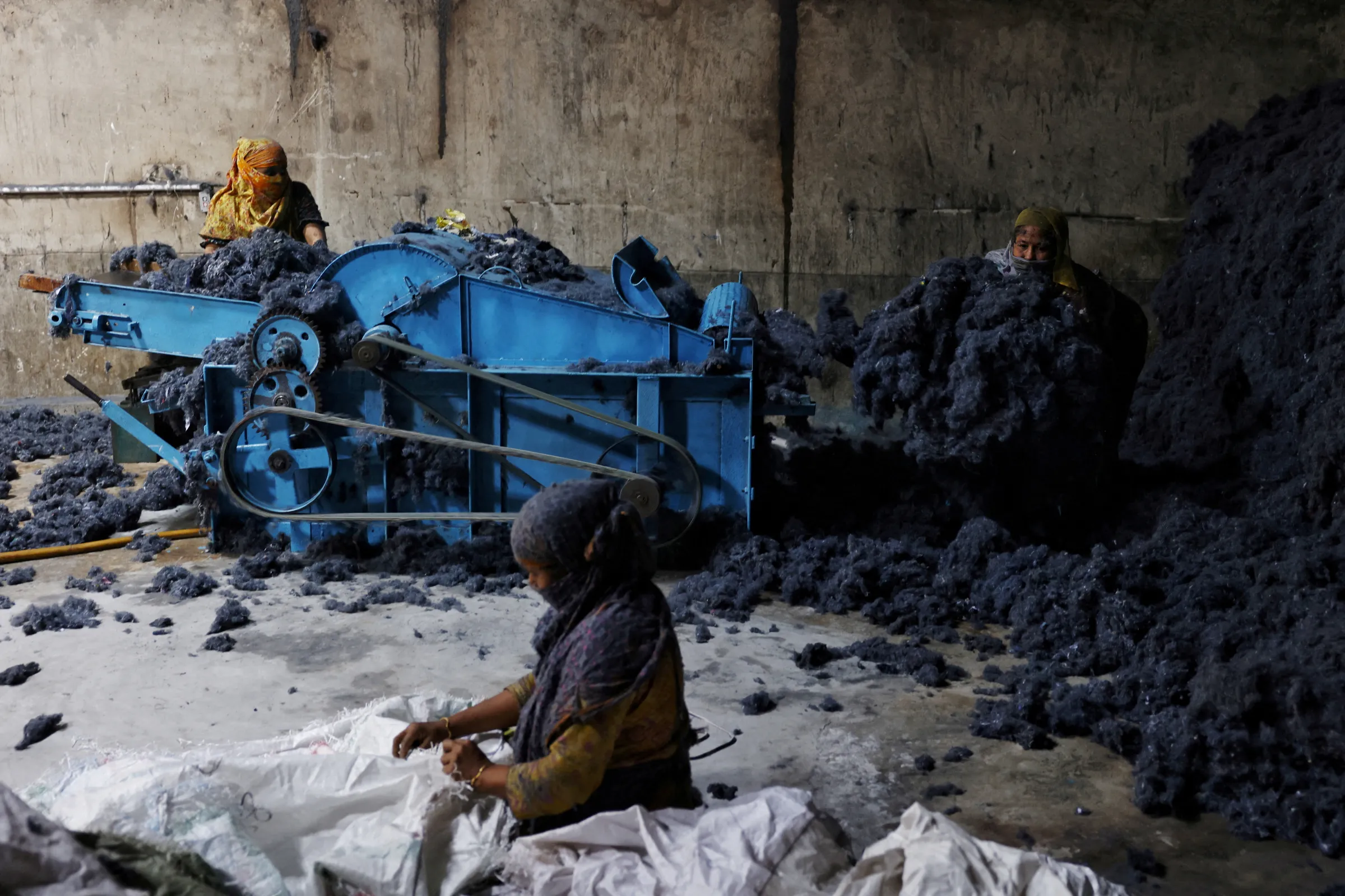 Women work in a factory where fabric waste from garments is transformed into cotton to make mattresses, in Narayanganj, Bangladesh, February 5, 2025. REUTERS/Mohammad Ponir Hossain