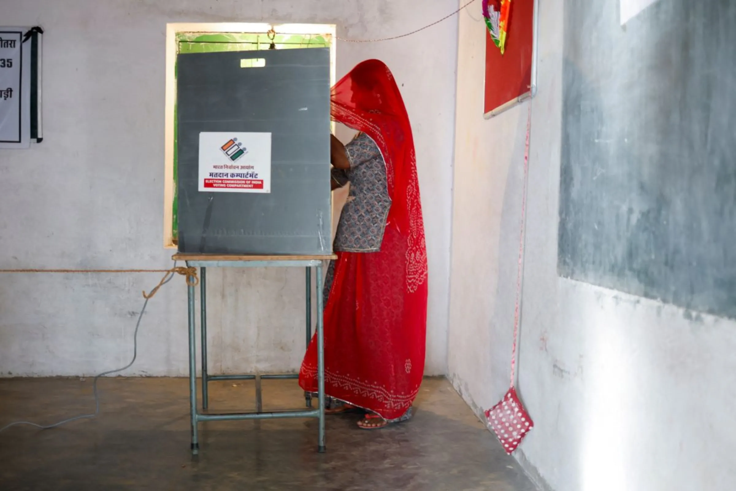 A woman votes at a polling station during the second phase of the general elections, in Barmer, Rajasthan, India, April 26, 2024. REUTERS/Adnan Abidi