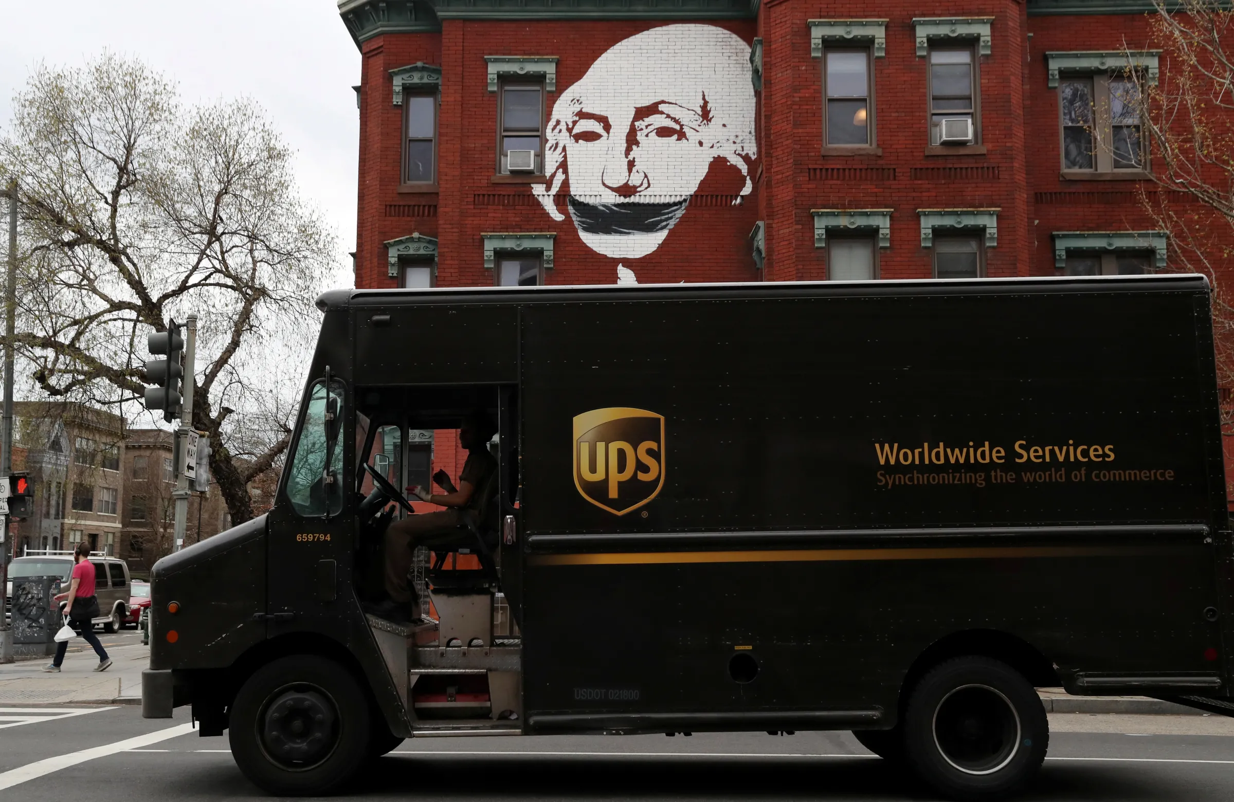 A delivery truck pauses at a traffic light in Washington, U.S., March 27, 2020