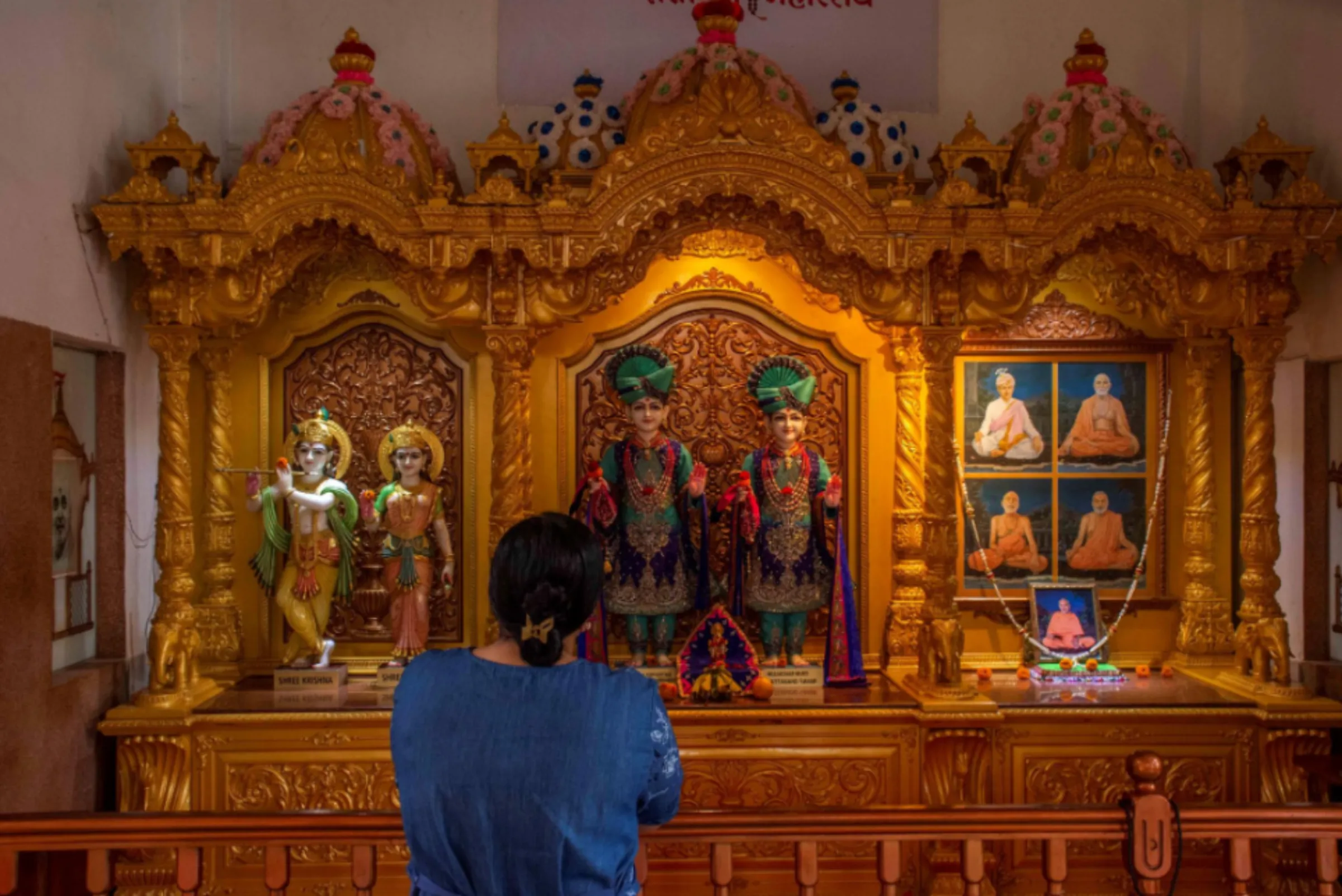 An Asian woman prays inside an Indian temple in Jinga District Uganda, October 1, 2022