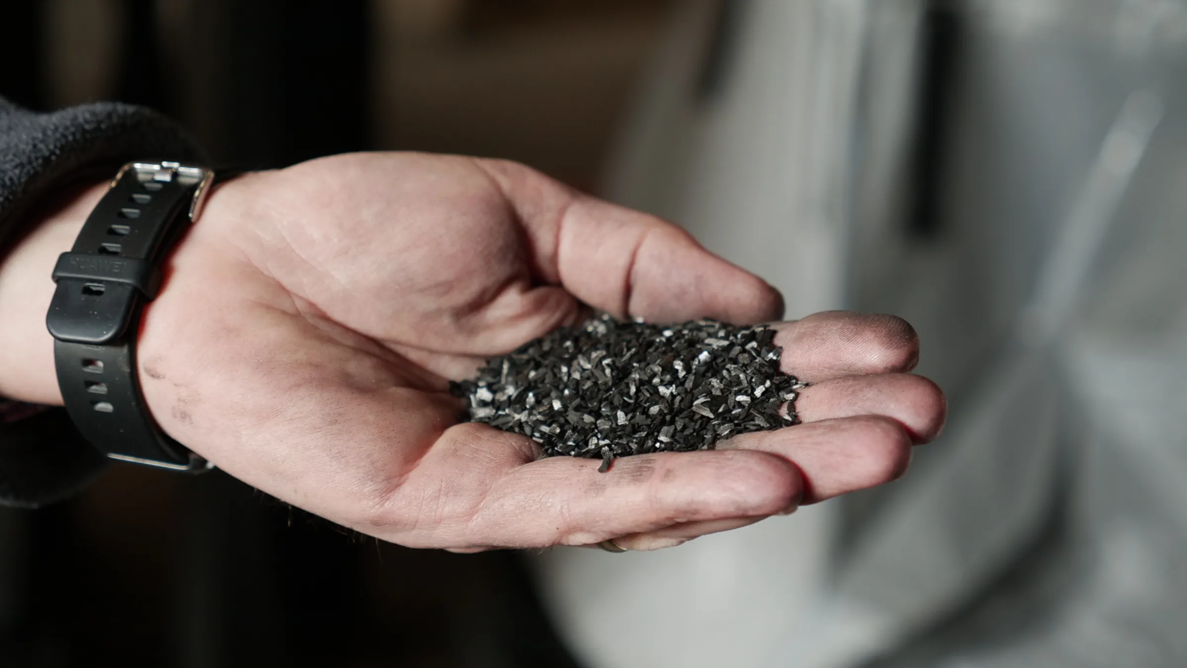 Darryl Phipps, the plant manager, holds a handful of activate carbon in his hand in Brakpan, Johannesburg, South Africa, June 8, 2025. Thomson Reuters Foundation/Kim Harrisberg